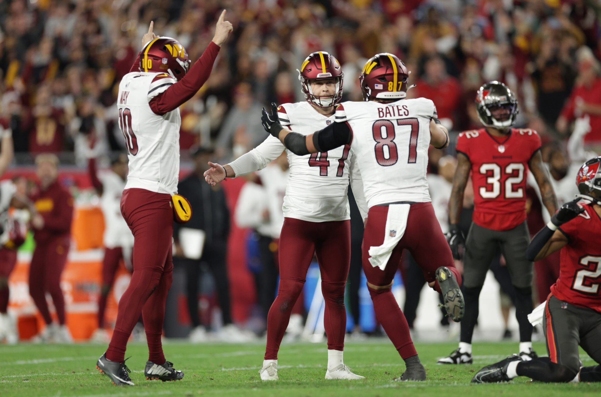 Washington Commanders place kicker Zane Gonzalez (47) celebrates after the game-wining field goal with punter Tress Way (10) and tight end John Bates (87) during the fourth quarter of a NFC wild card playoff against the Tampa Bay Buccaneers at Raymond James Stadium.