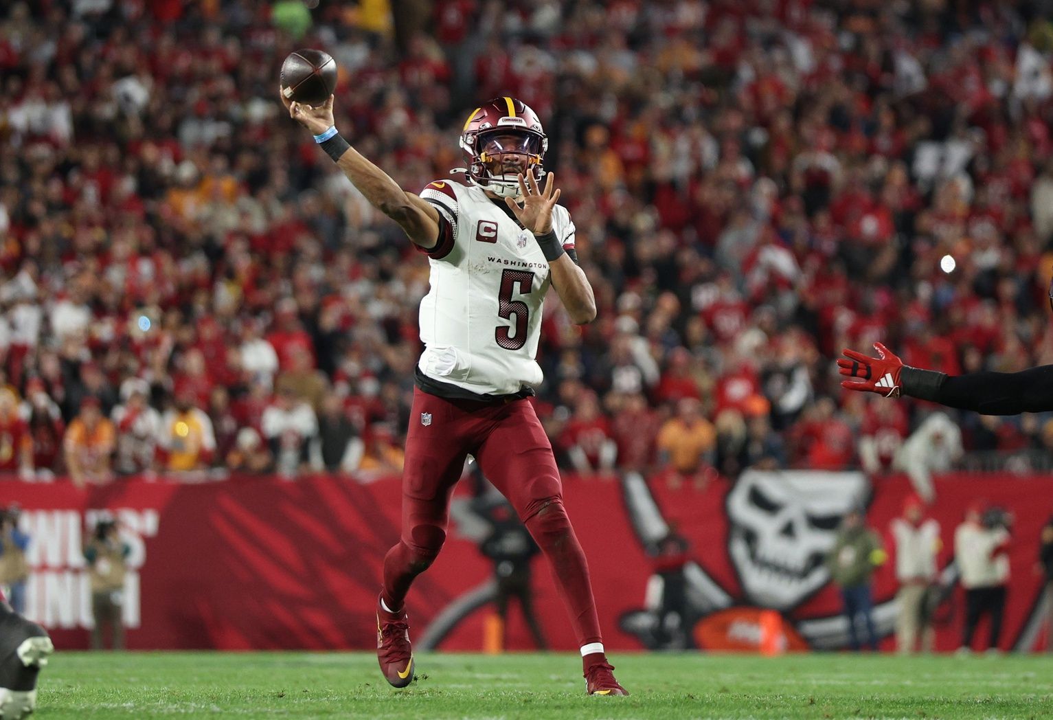 Washington Commanders quarterback Jayden Daniels (5) throws during the second quarter of a NFC wild card playoff against the Tampa Bay Buccaneers at Raymond James Stadium.