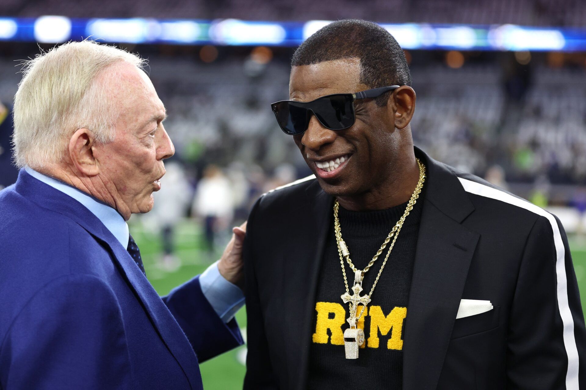 Colorado Buffaloes head coach Deion Sanders (right) talks with Dallas Cowboys owner Jerry Jones before the game against the Seattle Seahawks at AT&T Stadium.