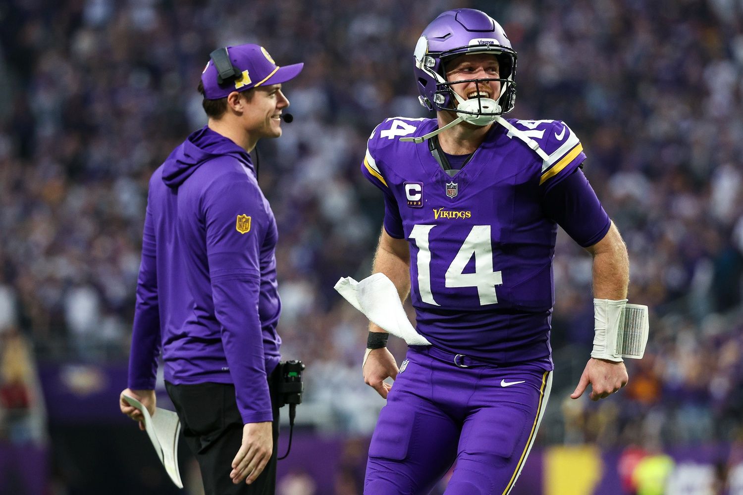 Minnesota Vikings quarterback Sam Darnold (14) celebrates running back Aaron Jones' (33) touchdown run with head coach Kevin O'Connell during the fourth quarter against the Atlanta Falcons at U.S. Bank Stadium.