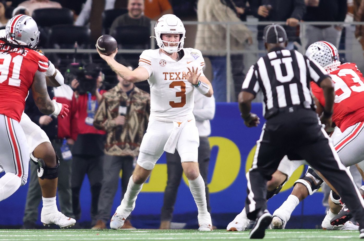 Texas Longhorns quarterback Quinn Ewers (3) throws during the second quarter of the College Football Playoff semifinal against the Ohio State Buckeyes in the Cotton Bowl at AT&T Stadium.