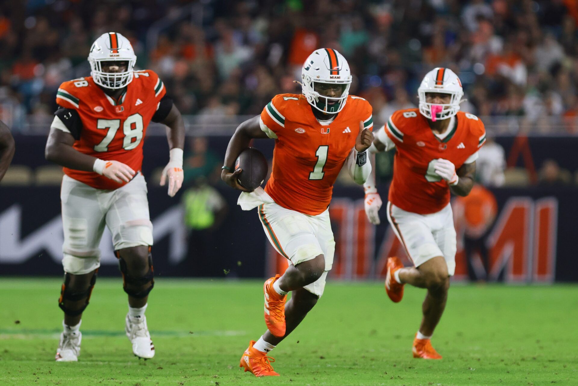 Miami Hurricanes quarterback Cam Ward (1) runs with the football against the Virginia Tech Hokies during the third quarter at Hard Rock Stadium.