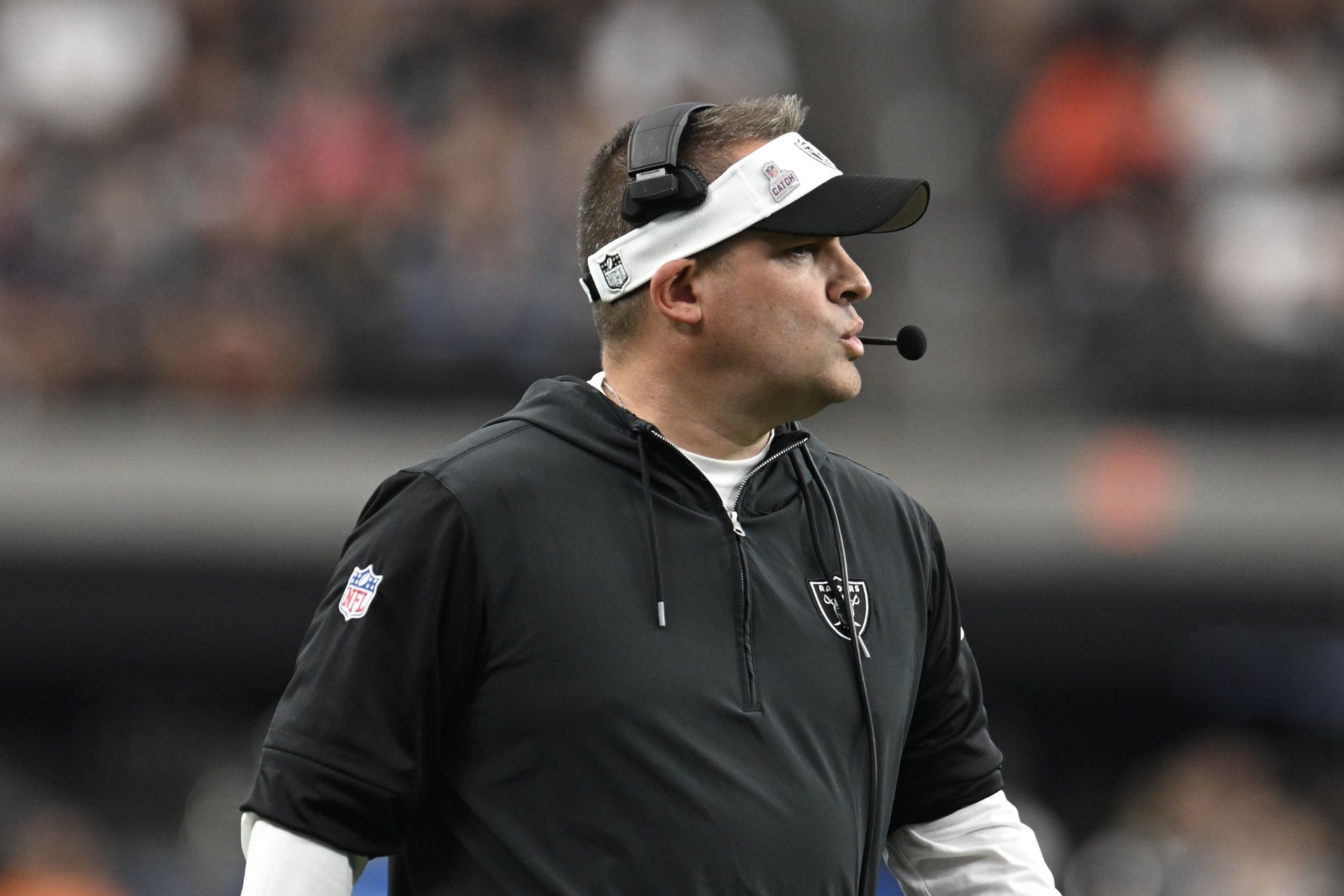 Las Vegas Raiders head coach Josh McDaniels looks down field against the New England Patriots in the fourth quarter at Allegiant Stadium.