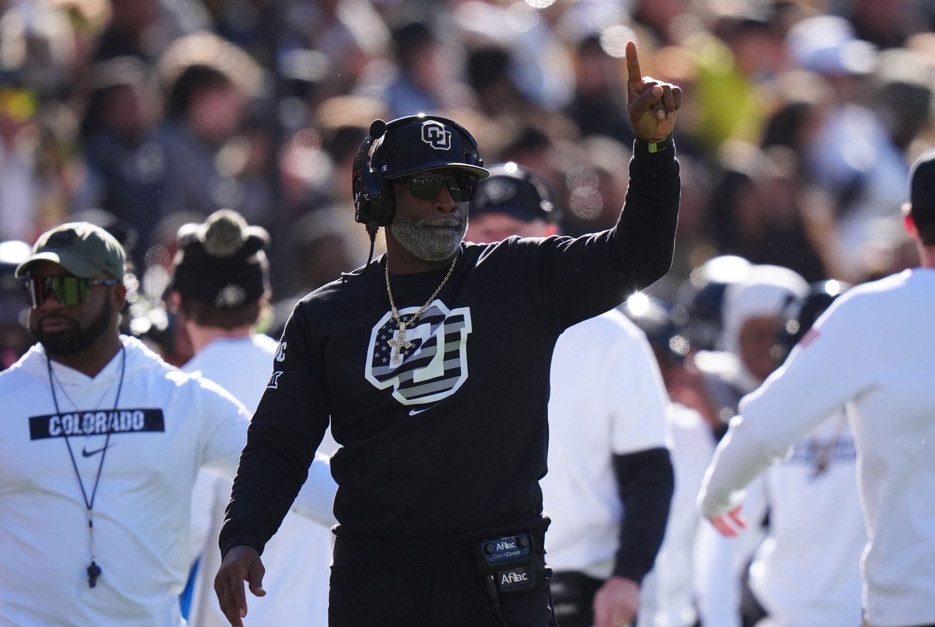 Colorado Buffaloes head coach Deion Sanders calls in a play in the first quarter against the Utah Utes at Folsom Field.