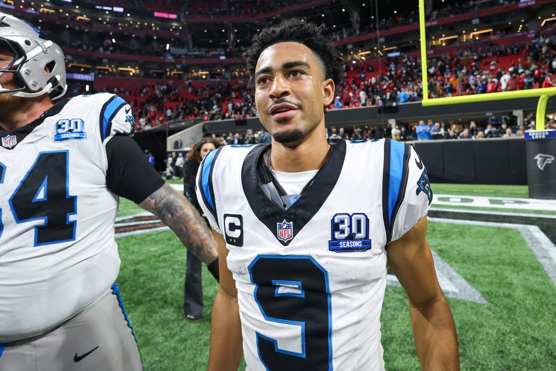 Carolina Panthers quarterback Bryce Young (9) celebrates with teammates after a victory over the Atlanta Falcons in overtime at Mercedes-Benz Stadium.