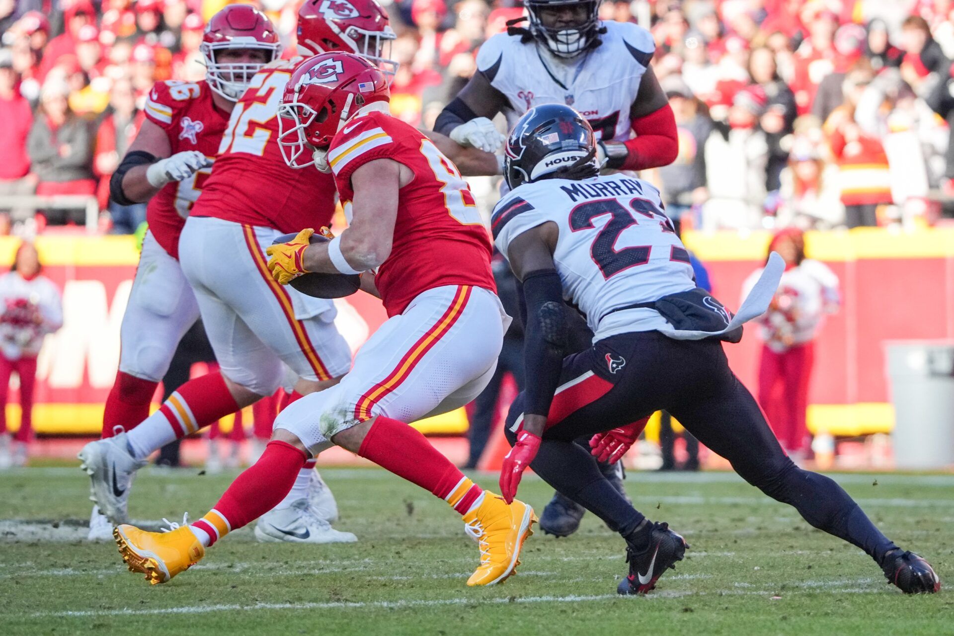 Kansas City Chiefs tight end Travis Kelce (87) catches a pass as Houston Texans safety Eric Murray (23) defends during the second half at GEHA Field at Arrowhead Stadium.