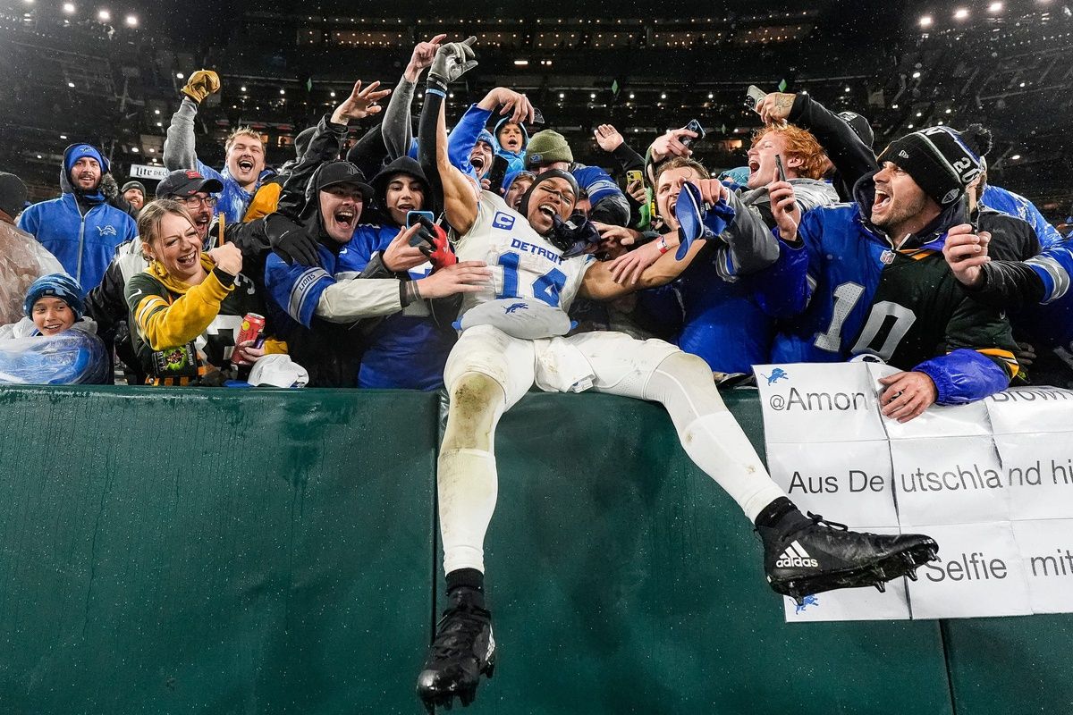 Detroit Lions wide receiver Amon-Ra St. Brown (14) leaps into Lions fans as they celebrate 24-14 win over Green Bay Packers at Lambeau Field in Green Bay, Wis. on Sunday, Nov. 3, 2024.