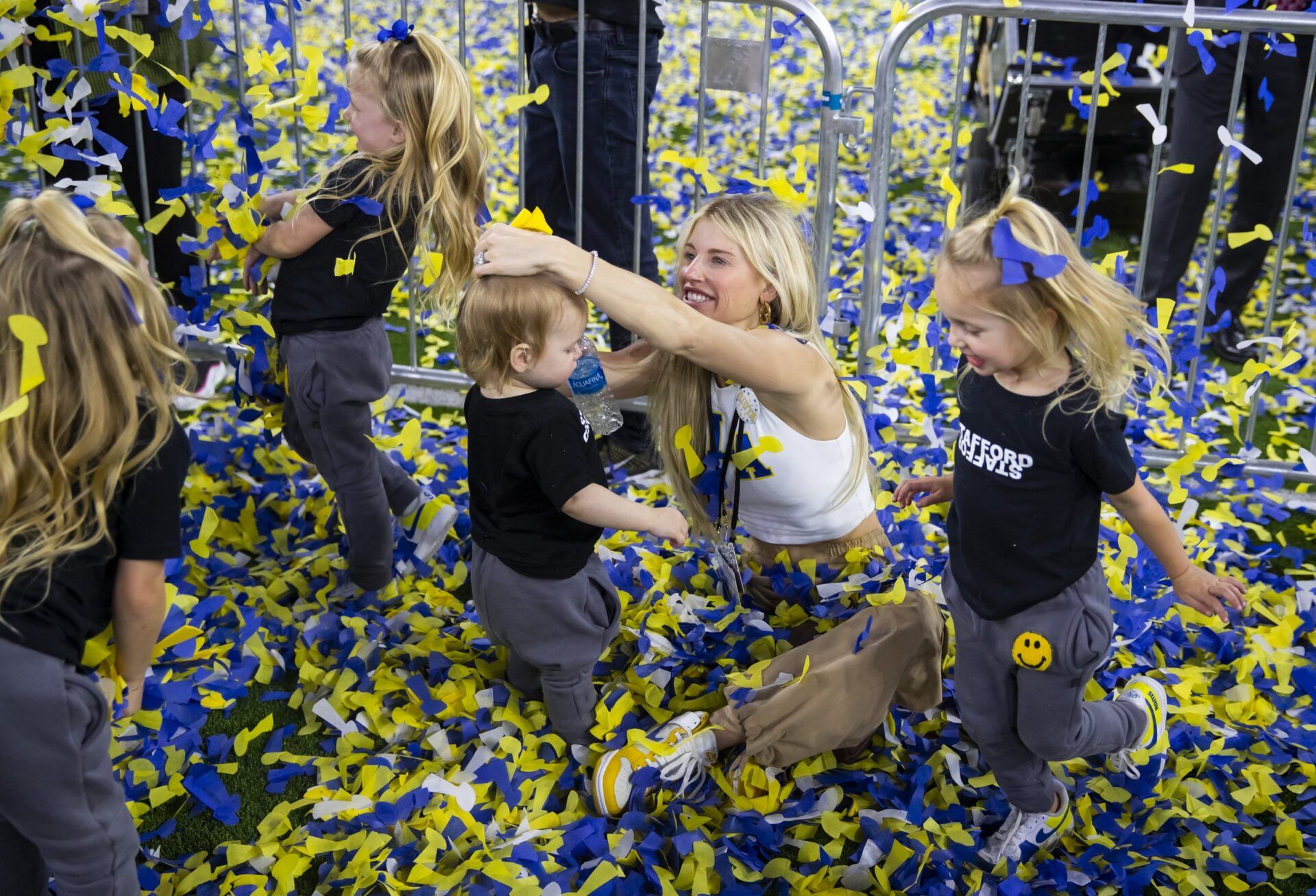 Kelly Stafford, wife of Los Angeles Rams quarterback Matthew Stafford (not pictured) plays with their daughters in the confetti as they celebrate after defeating the Cincinnati Bengals during Super Bowl LVI at SoFi Stadium.