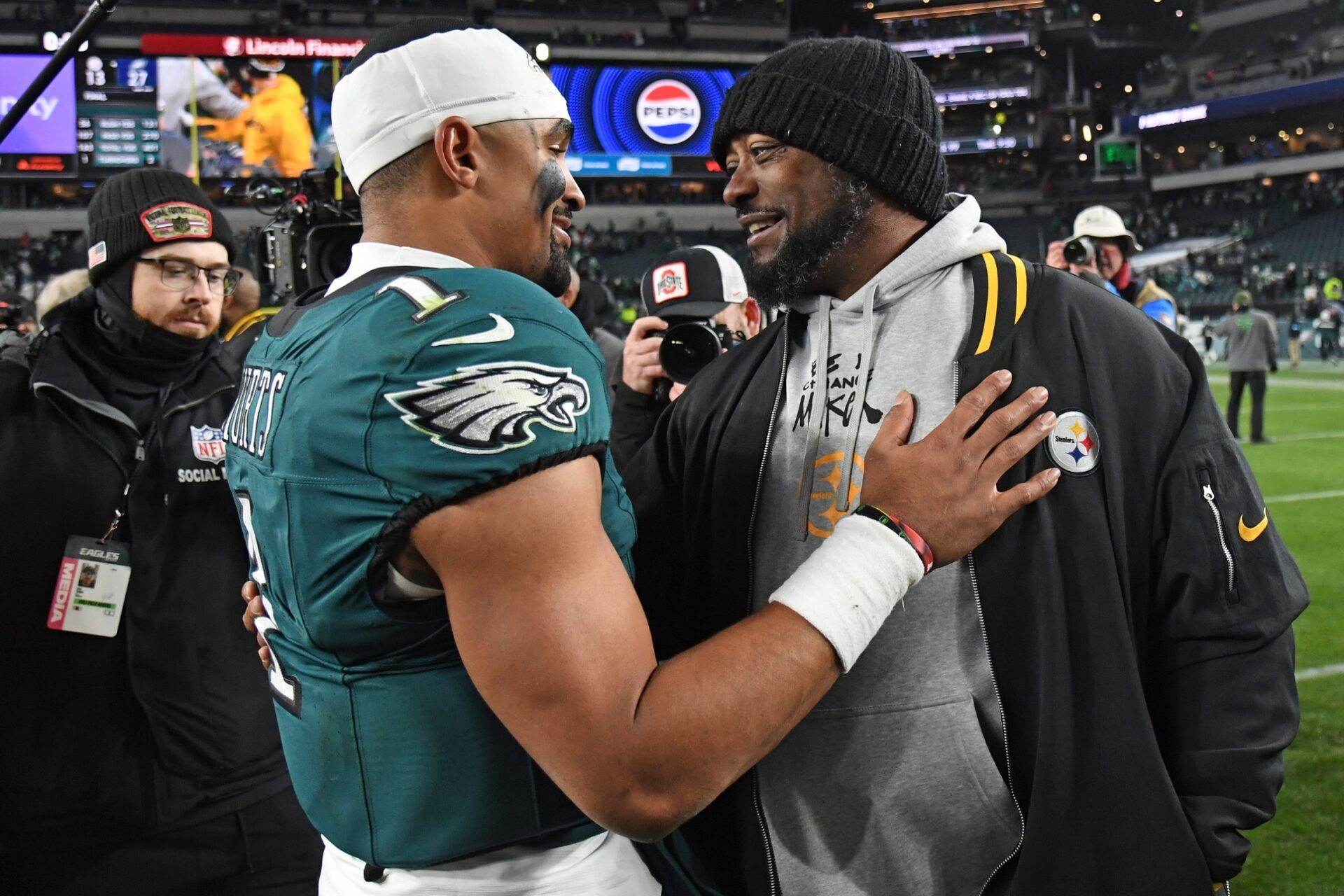 Philadelphia Eagles quarterback Jalen Hurts (1) and Pittsburgh Steelers head coach Mike Tomlin meet on the field after game at Lincoln Financial Field.