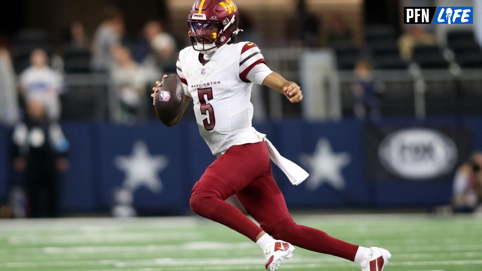 Washington Commanders quarterback Jayden Daniels (5) runs the ball against the Dallas Cowboys during the second quarter at AT&T Stadium