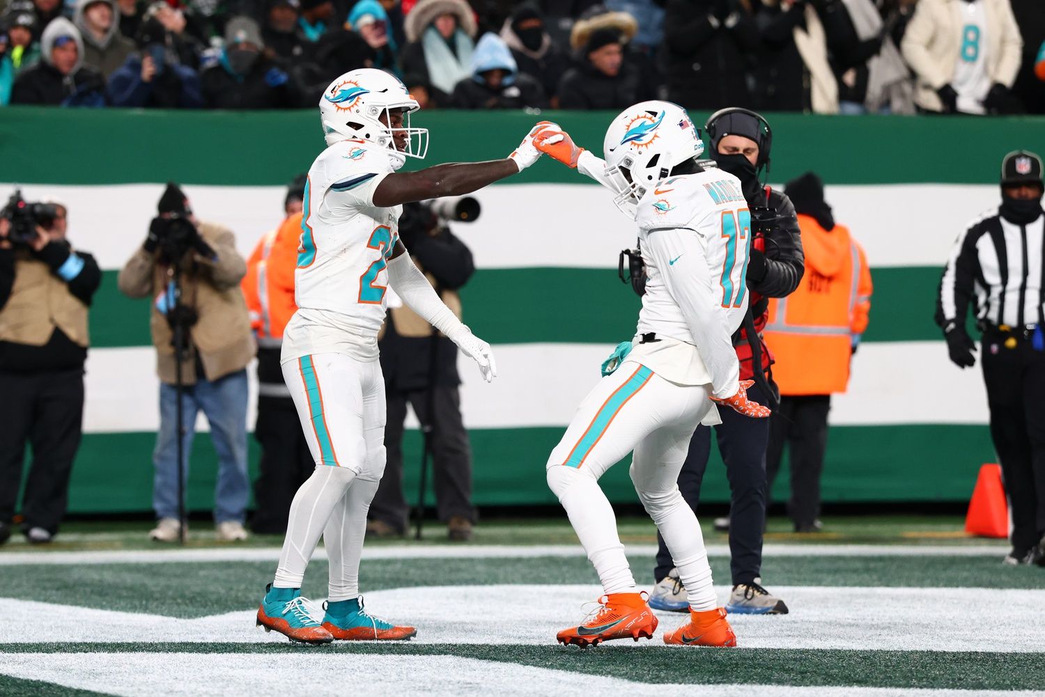 Miami Dolphins running back De'Von Achane (28) celebrates his touchdown run during the fourth quarter of their game against the New York Jets at MetLife Stadium.