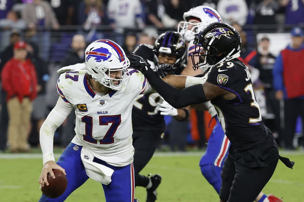 Buffalo Bills quarterback Josh Allen (17) scrambles from Baltimore Ravens safety Eddie Jackson (39) at M&T Bank Stadium.