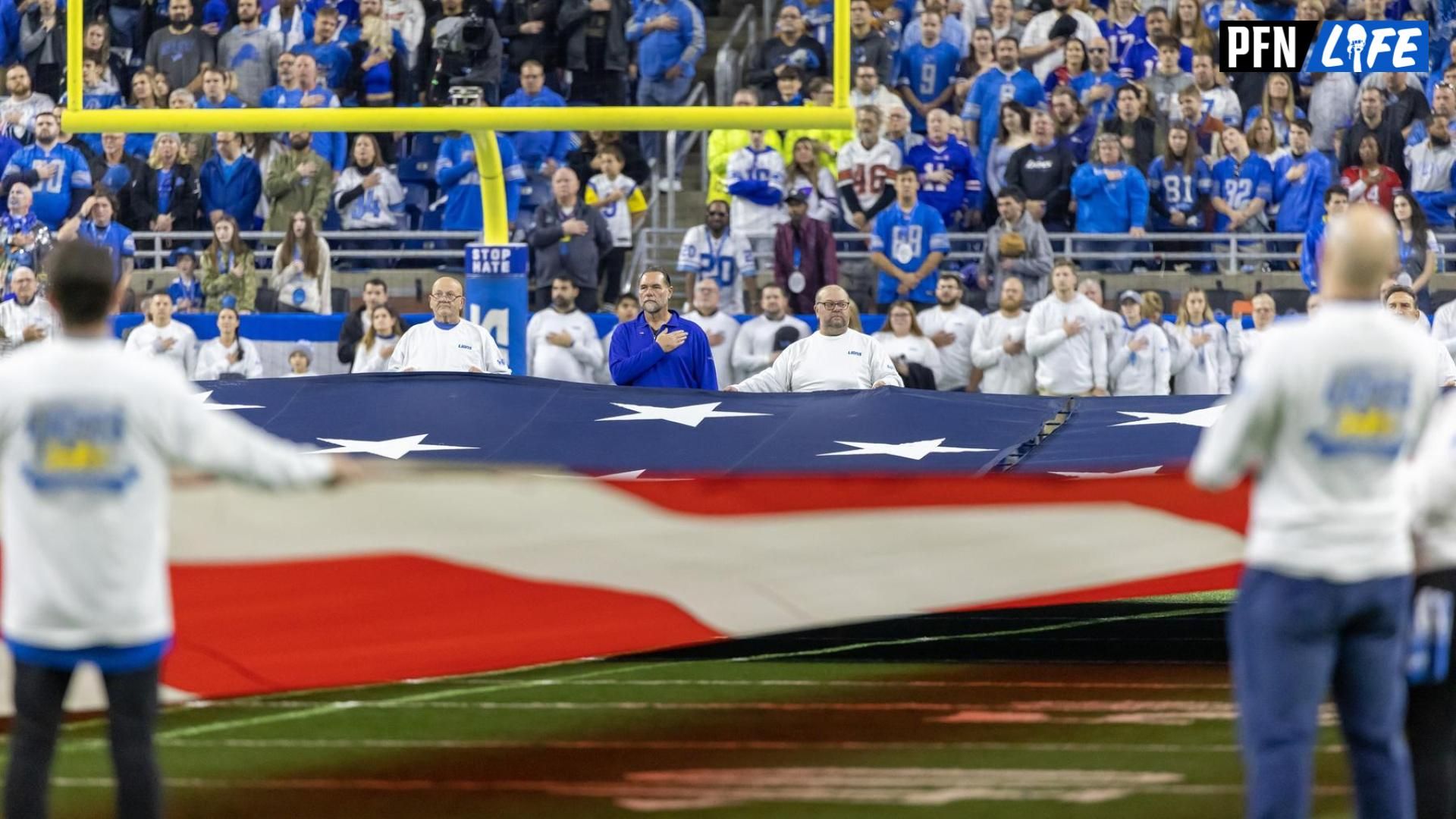 Fans stand for the National Anthem before the start of the game between the Detroit Lions and the Buffalo Bills at Ford Field.