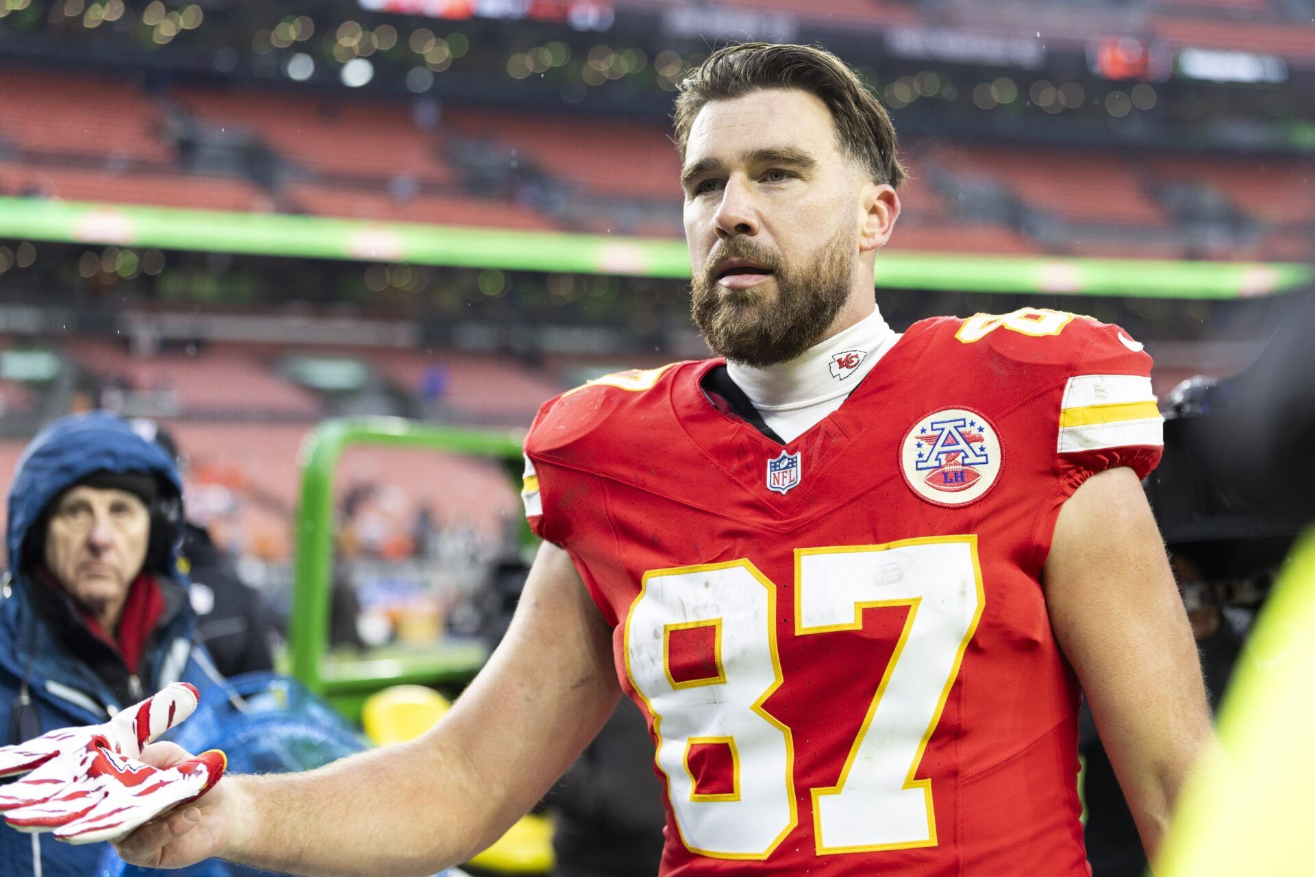 Kansas City Chiefs tight end Travis Kelce (87) gives his gloves to a fan following a game against the Cleveland Browns at Huntington Bank Field.