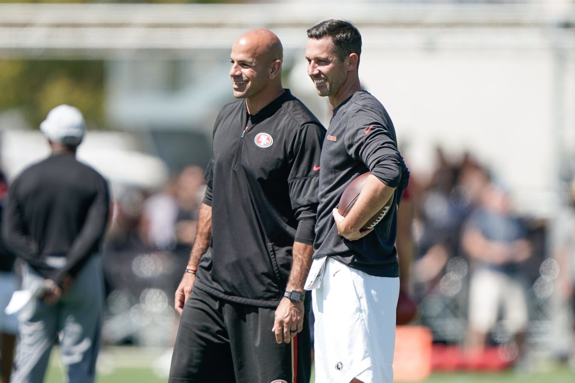 (l to r) San Francisco 49ers defensive coordinator Robert Saleh smiles alongside head coach Kyle Shanahan as they watch players participates during training camp at the SAP Performance Facility.