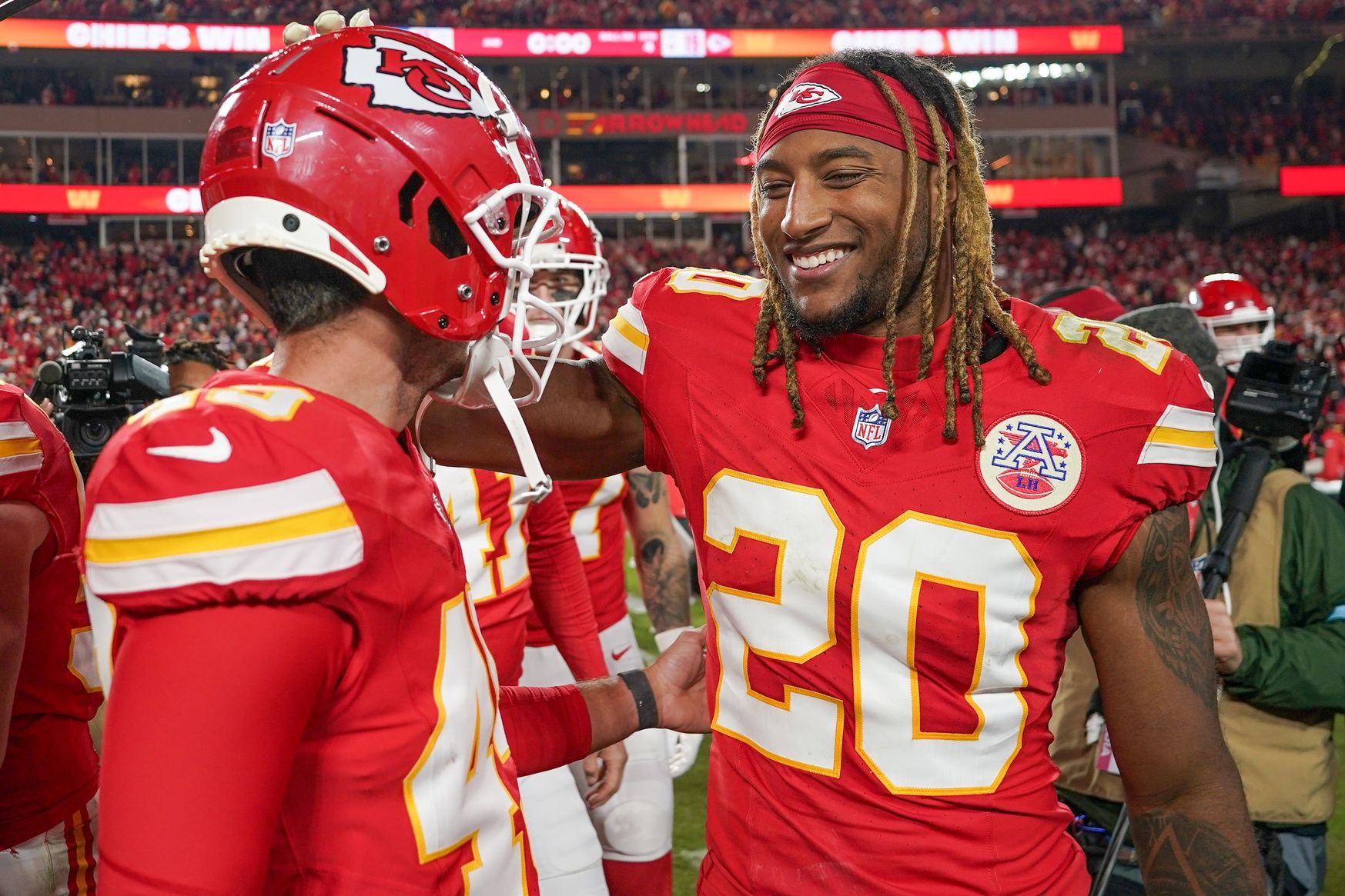 Kansas City Chiefs place kicker Matthew Wright (49) celebrates with safety Justin Reid (20) after the win over the Los Angeles Chargers at GEHA Field at Arrowhead Stadium.