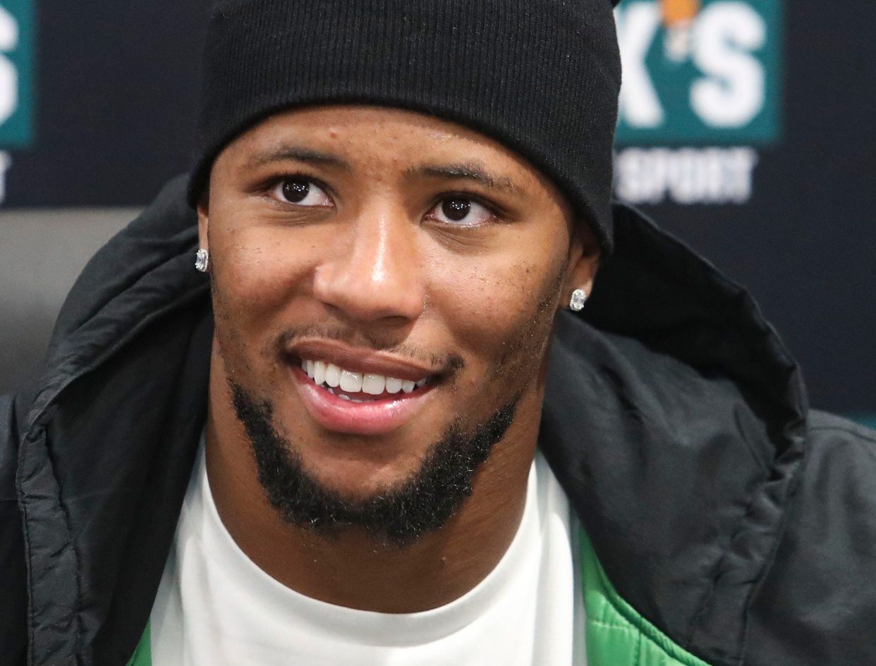 Eagles running back Saquon Barkley smiles for photos as he makes an autograph signing appearance to promote the opening of the Dick's House of Sport store at the Brandywine Town Center, Friday, Oct. 11, 2024.