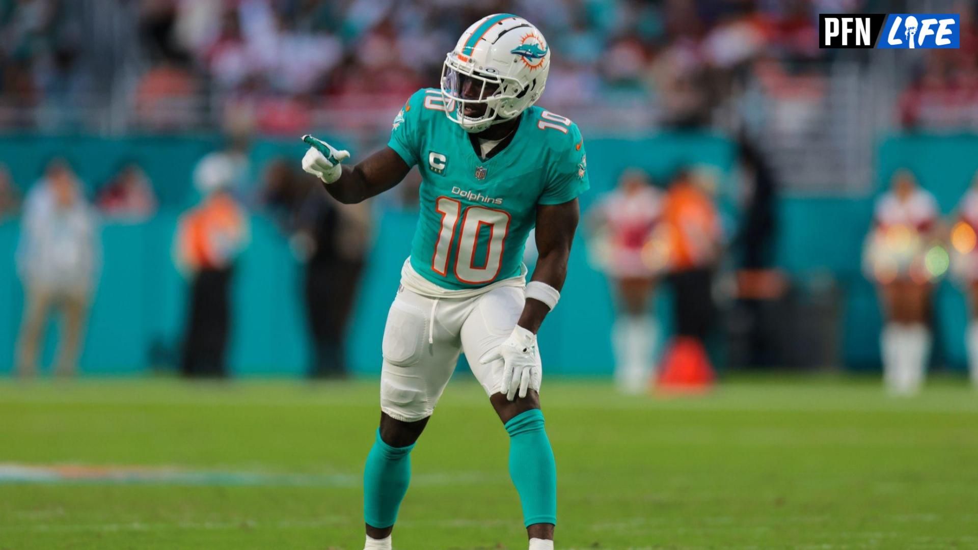 Miami Dolphins wide receiver Tyreek Hill (10) signals from the line of scrimmage against the San Francisco 49ers during the second quarter at Hard Rock Stadium.