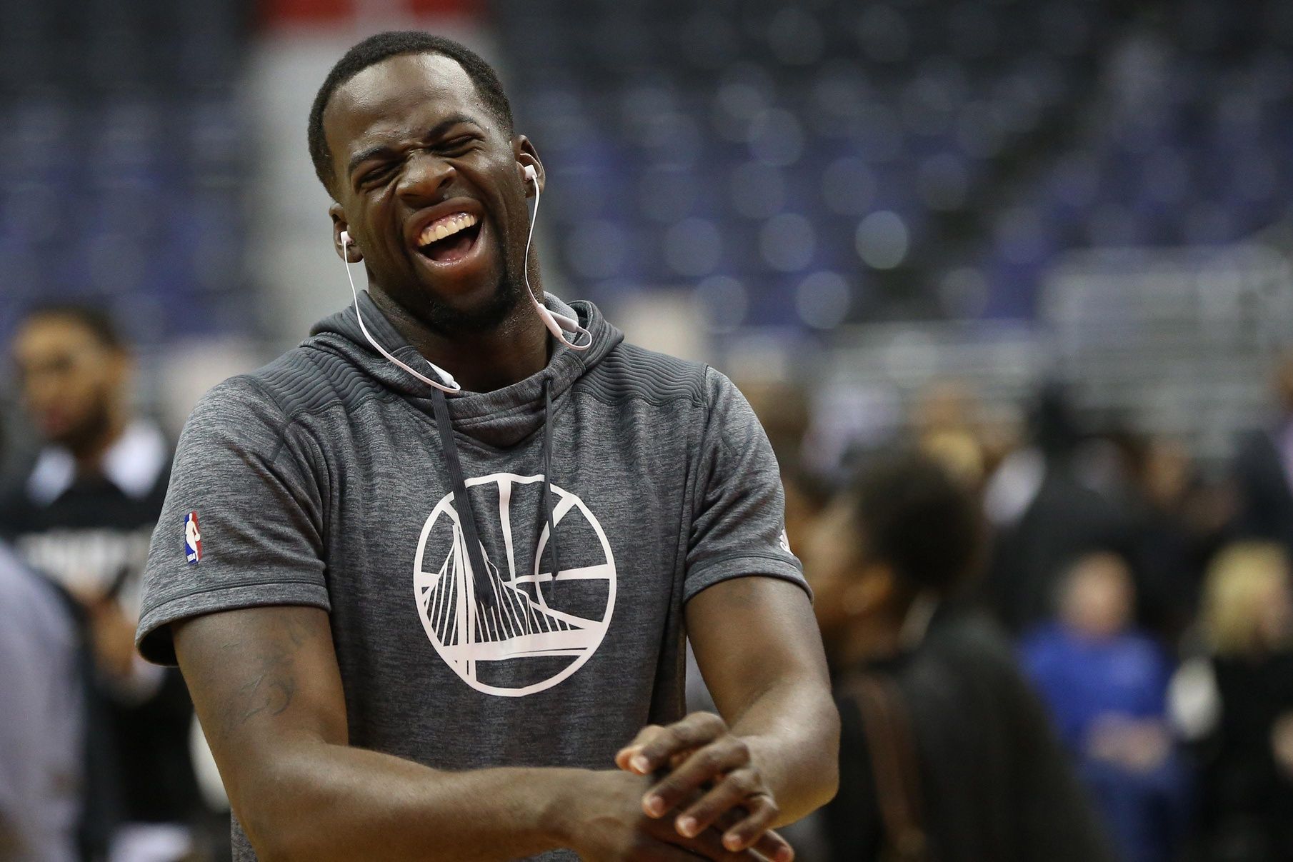 Golden State Warriors forward Draymond Green smiles on the court during warm-ups prior to the Warriors' game against the Washington Wizards at Verizon Center.