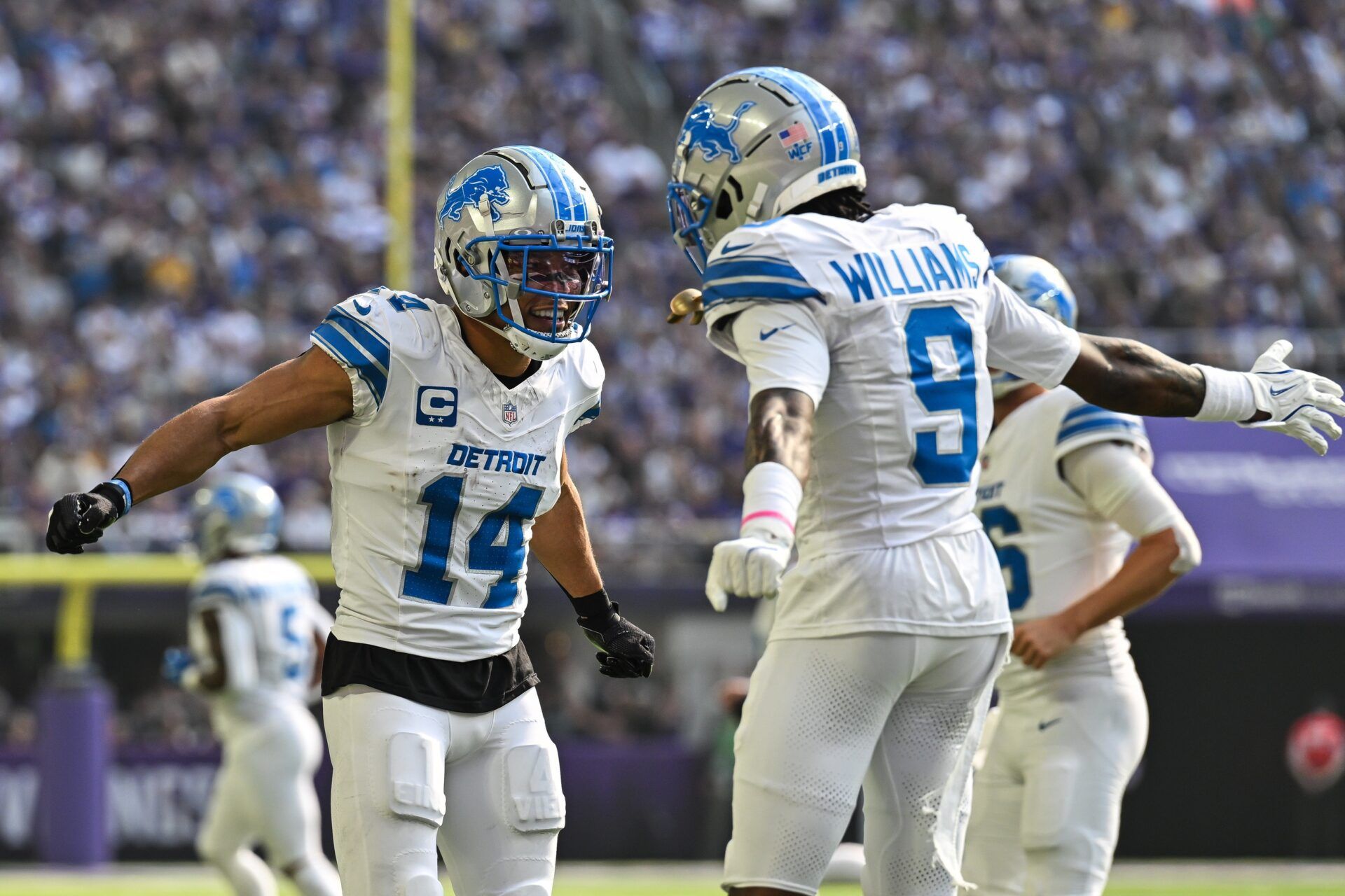 Detroit Lions wide receiver Amon-Ra St. Brown (14) reacts with wide receiver Jameson Williams (9) after catching a 35 yard touchdown pass from quarterback Jared Goff (not pictured) against the Minnesota Vikings the second quarter at U.S. Bank Stadium.