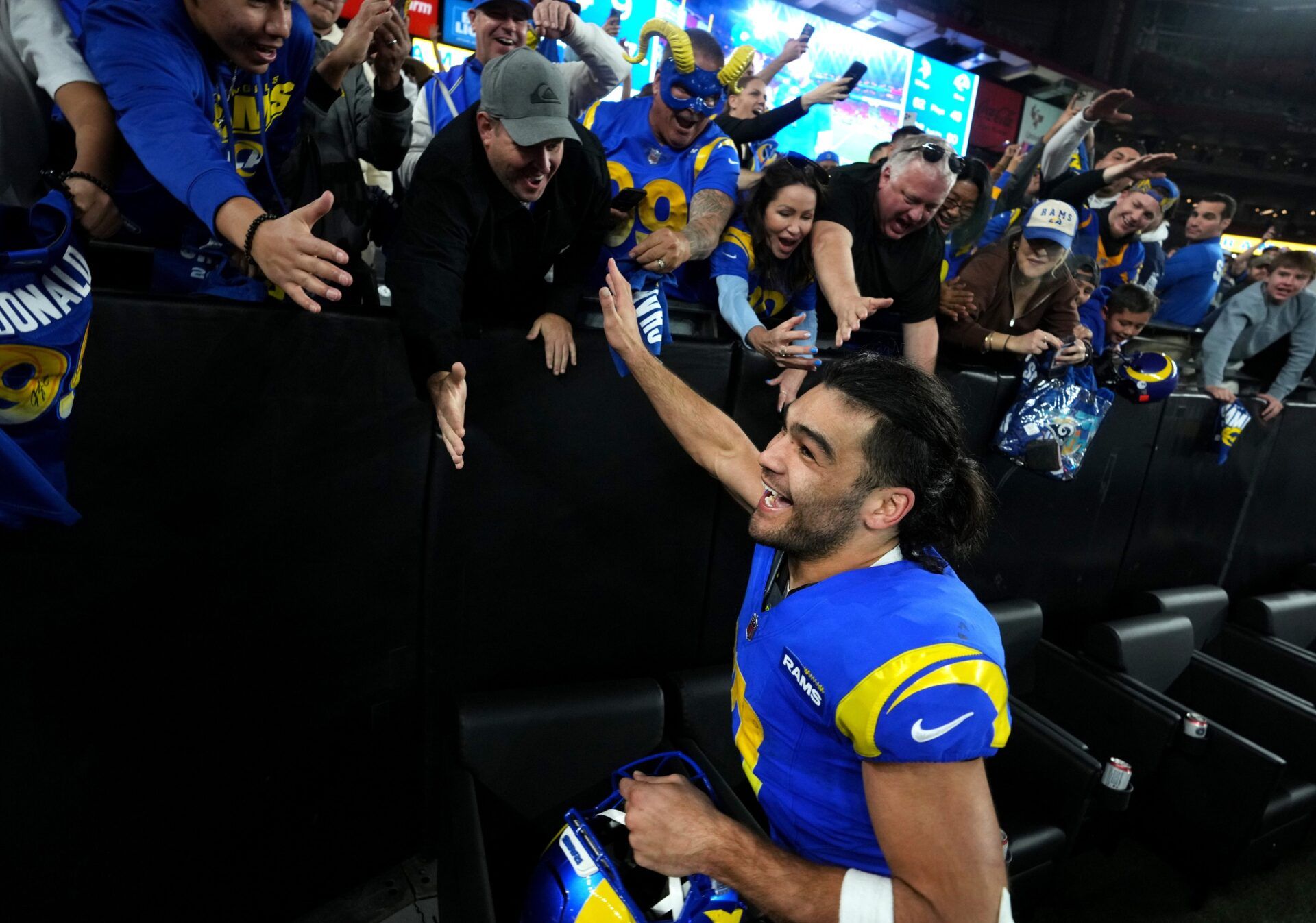 Los Angeles Rams receiver Puka Nacua (17) high-fives fans after their 27-9 playoff win over the Minnesota Vikings at State Farm Stadium on Jan. 13, 2025, in Glendale.