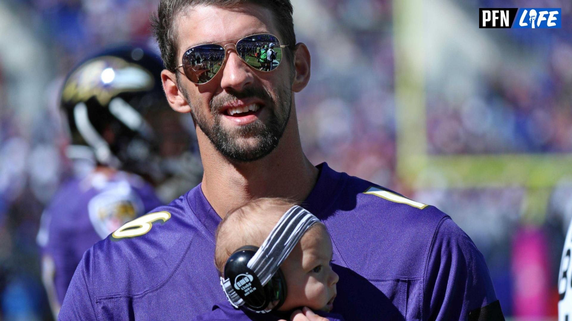 United States olympian Michael Phelps and his son Boomer attend the Washington Redskins game against the Baltimore Ravens at M&T Bank Stadium.