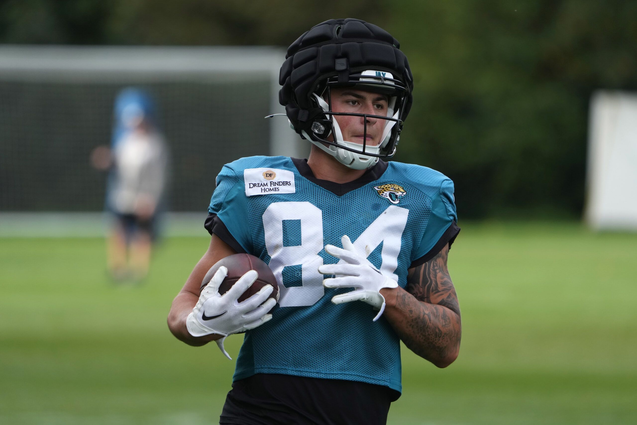 Jacksonville Jaguars wide receiver Louis Rees-Zammit (84) wears a Guardian helmet cap during practice at The Grove.