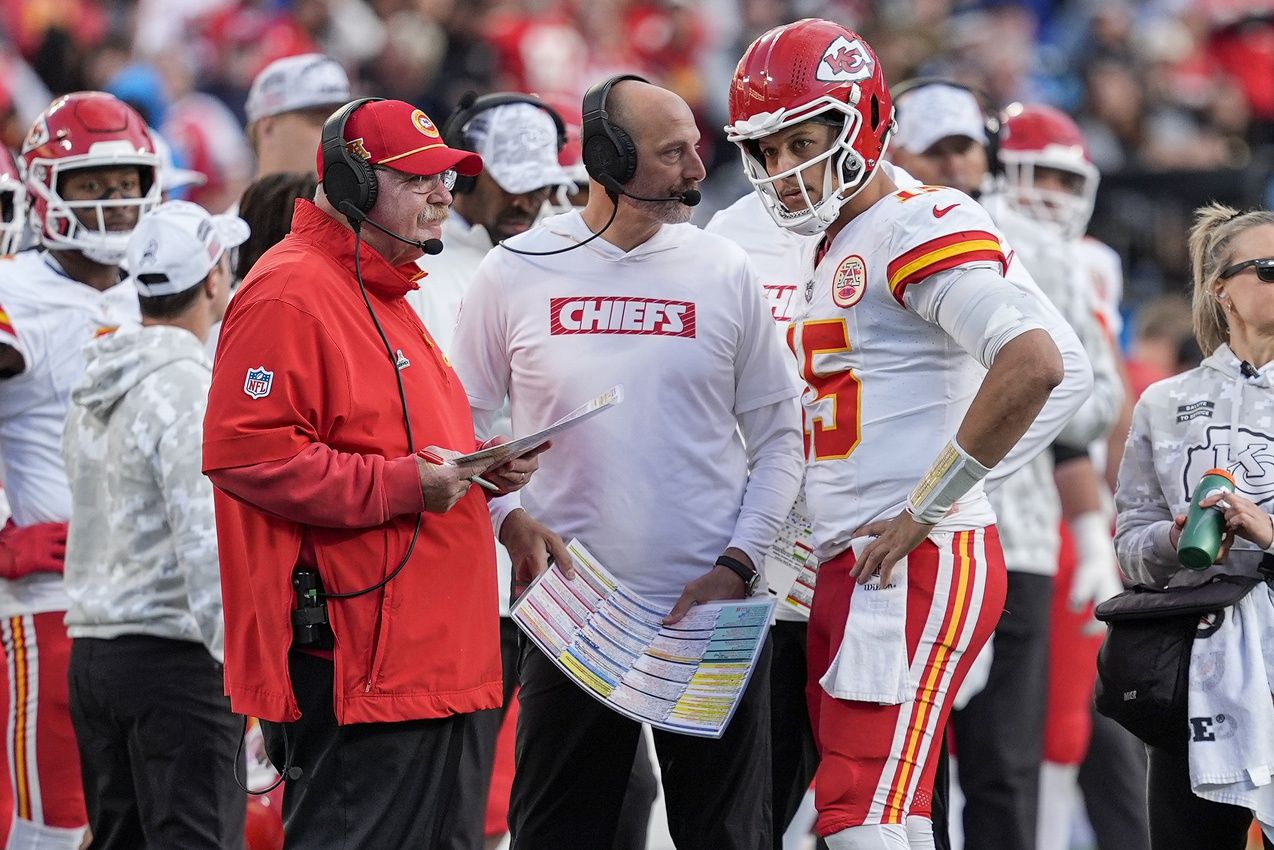 Kansas City Chiefs head coach Andy Reid talks with quarterback Patrick Mahomes (15) during a time out during the second half against the Carolina Panthers at Bank of America Stadium.