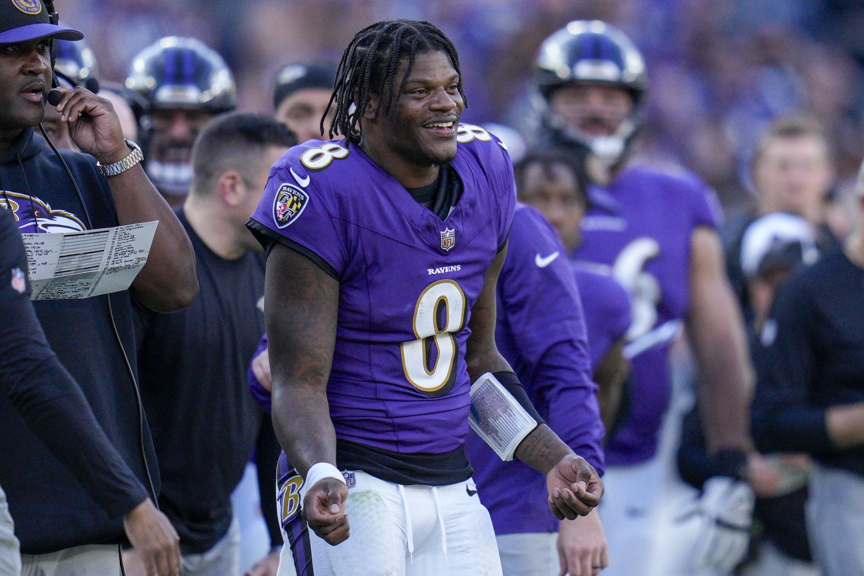 Baltimore Ravens quarterback Lamar Jackson (8) smiles on the sidelines during the fourth quarter against the Seattle Seahawks at M&T Bank Stadium.