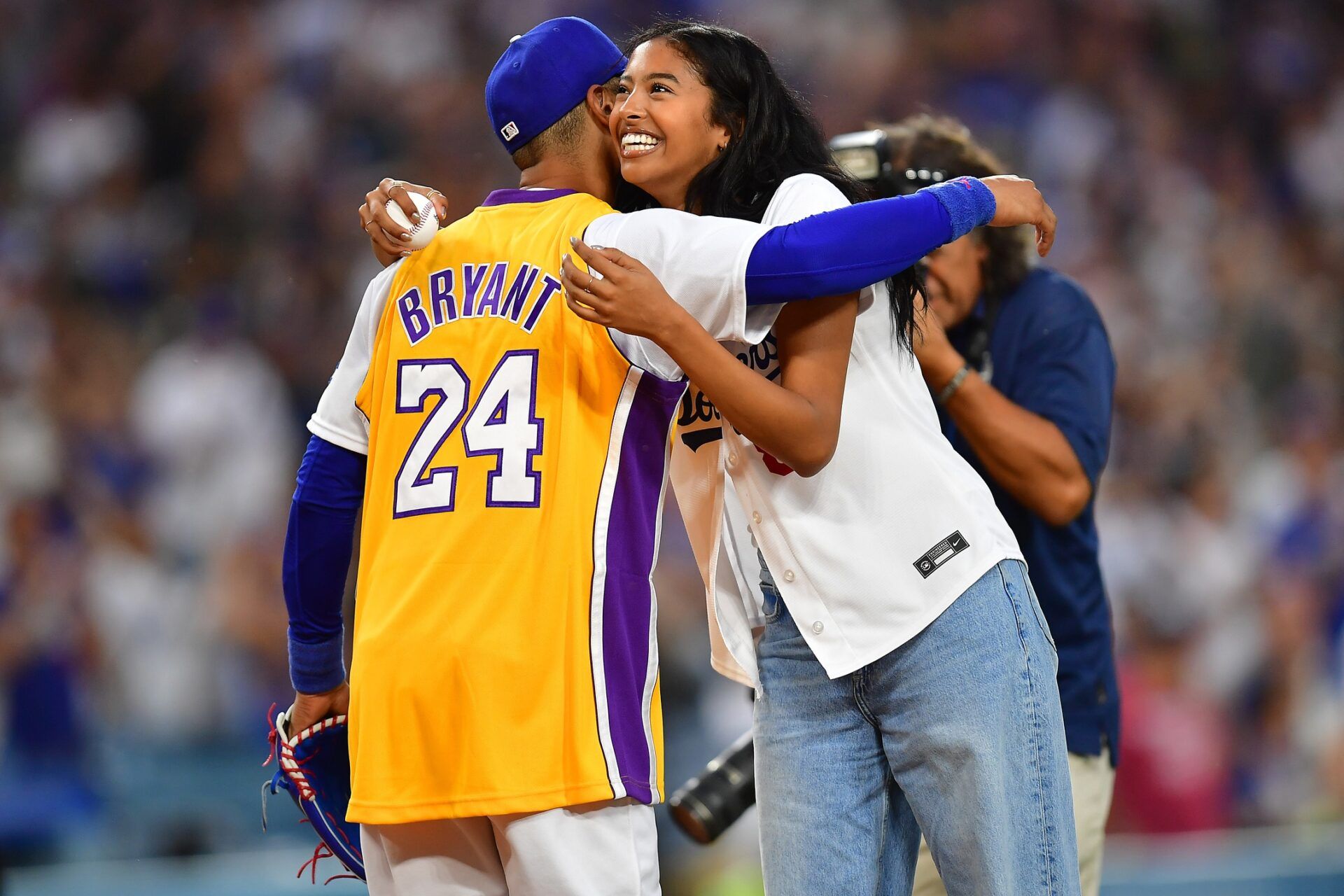 Natalia Bryant is greeted by Los Angeles Dodgers right fielder Mookie Betts (50) after throwing out the ceremoninial first pitch at Dodger Stadium.