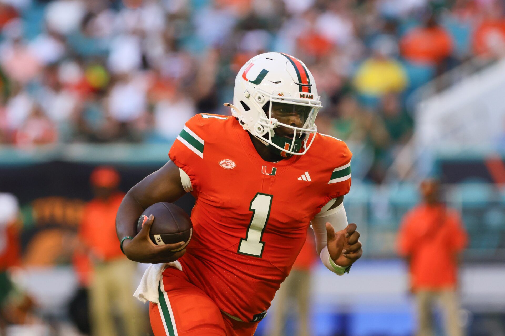 Miami Hurricanes quarterback Cam Ward (1) runs with the football against the Florida A&M Rattlers during the second quarter at Hard Rock Stadium.