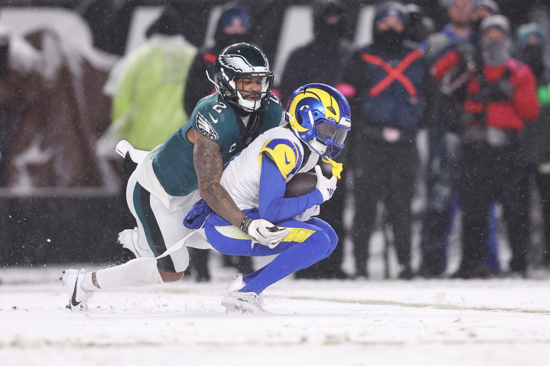 Los Angeles Rams wide receiver Tutu Atwell (5) catches a pass as Philadelphia Eagles cornerback Darius Slay Jr. (2) defends in the second half in a 2025 NFC divisional round game at Lincoln Financial Field.