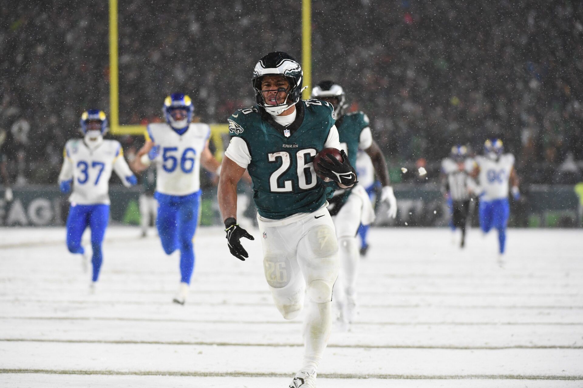 Philadelphia Eagles running back Saquon Barkley (26) carries the ball to score a touchdown against the Los Angeles Rams in the second half in a 2025 NFC divisional round game at Lincoln Financial Field.