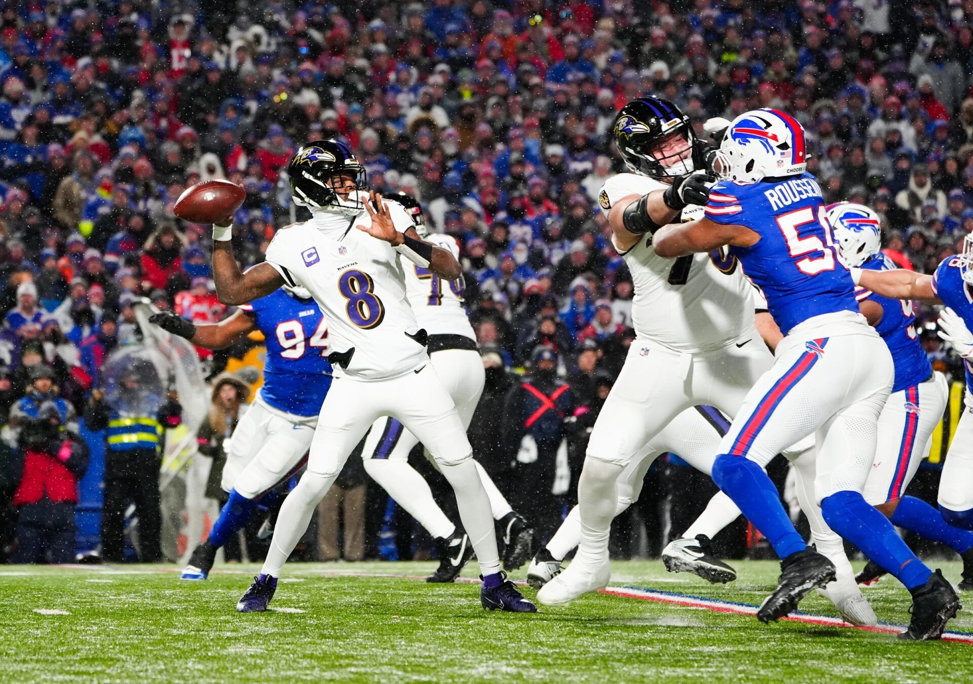 Baltimore Ravens quarterback Lamar Jackson (8) drops back to pass during the first quarter against the Buffalo Bills in a 2025 AFC divisional round game at Highmark Stadium.