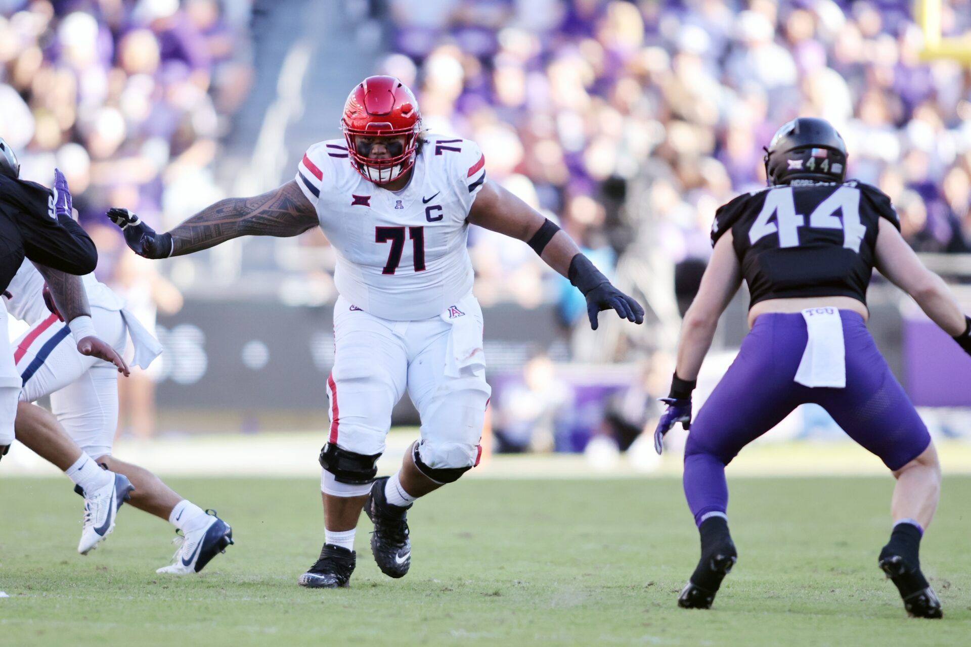 Arizona Wildcats offensive lineman Jonah Savaiinaea (71) blocks in the second quarter against the TCU Horned Frogs at Amon G. Carter Stadium.