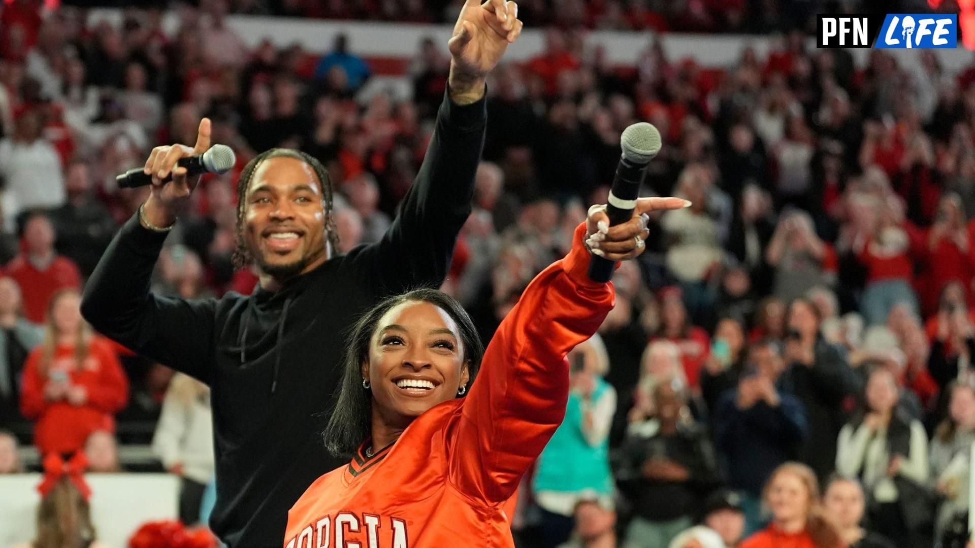 Simone Biles calls the Dawg with her husband Jonathan Owens during a NCAA gymnastics meet against Boise State in Athens, Ga., on Friday, Jan. 17, 2024. Georgia won 196.825 to 193.600.