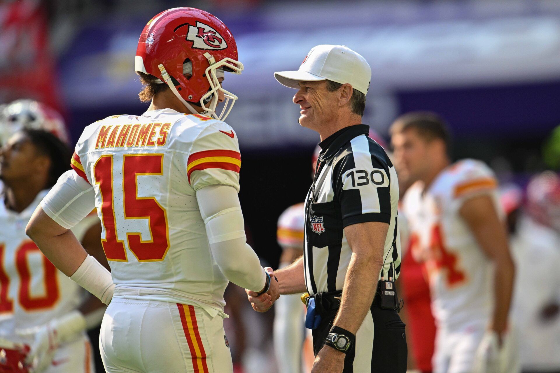 Kansas City Chiefs quarterback Patrick Mahomes (15) shakes hands with referee Land Clark (130) before the game against the Minnesota Vikings at U.S. Bank Stadium.