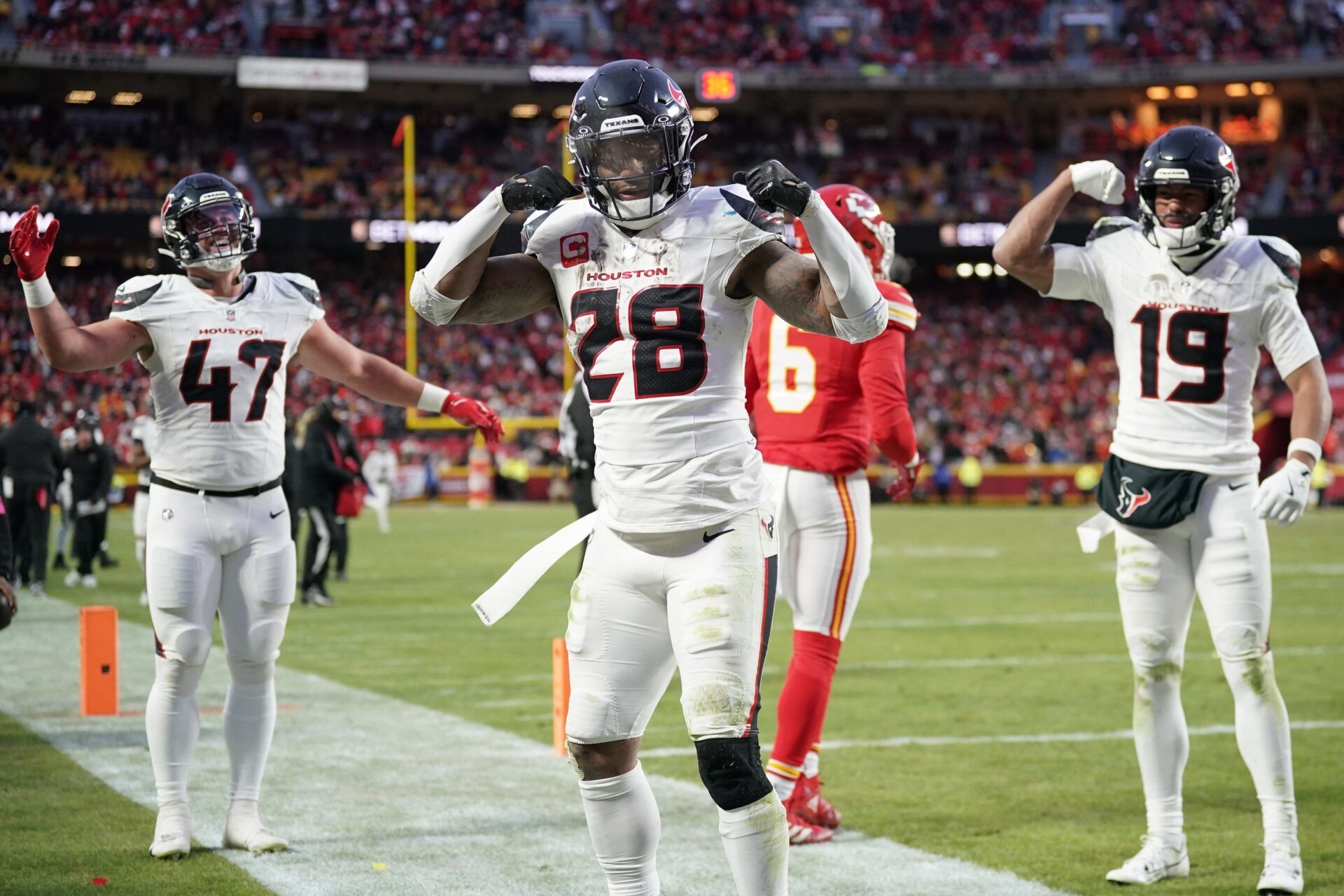 Houston Texans running back Joe Mixon (28) celebrates with fullback Andrew Beck (47) and wide receiver Xavier Hutchinson (19) after scoring a touchdown against the Kansas City Chiefs during the third quarter of a 2025 AFC divisional round game at GEHA Field at Arrowhead Stadium.