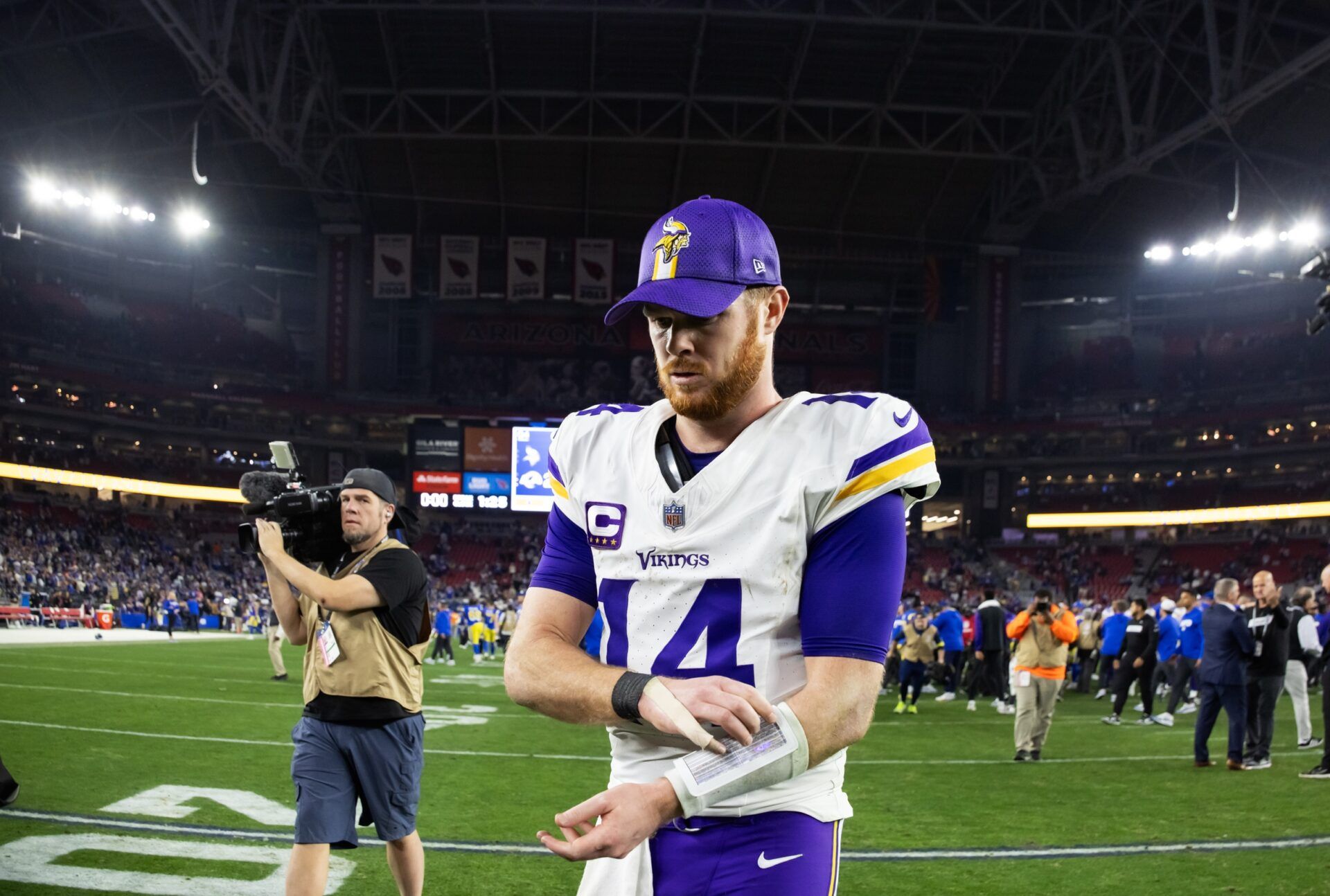 Minnesota Vikings quarterback Sam Darnold (14) reacts as he walks off the field after losing to the Los Angeles Rams during an NFC wild card game at State Farm Stadium.