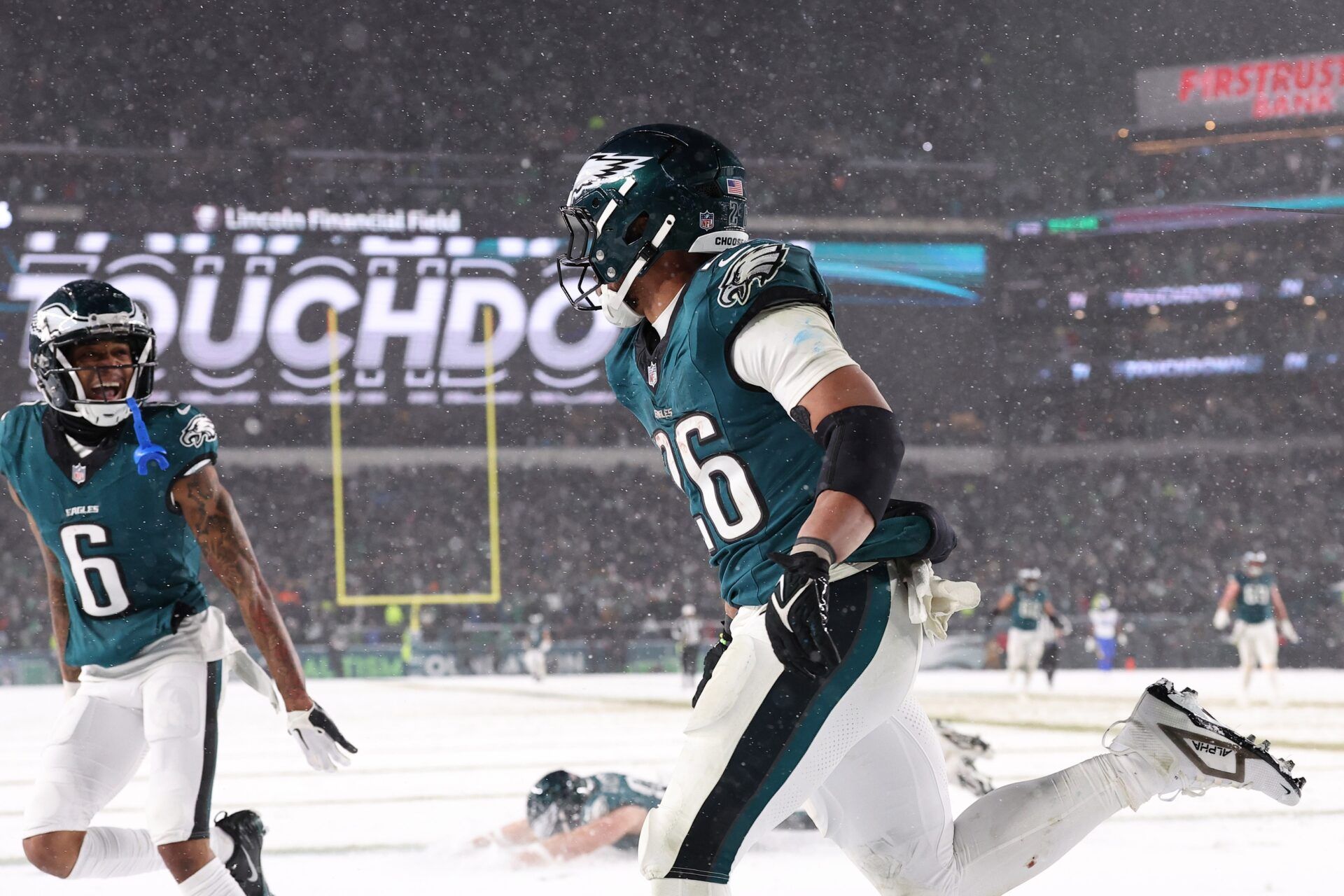 Philadelphia Eagles running back Saquon Barkley (26) celebrates after scoring a touchdown in the second half against the Los Angeles Rams in a 2025 NFC divisional round game at Lincoln Financial Field.