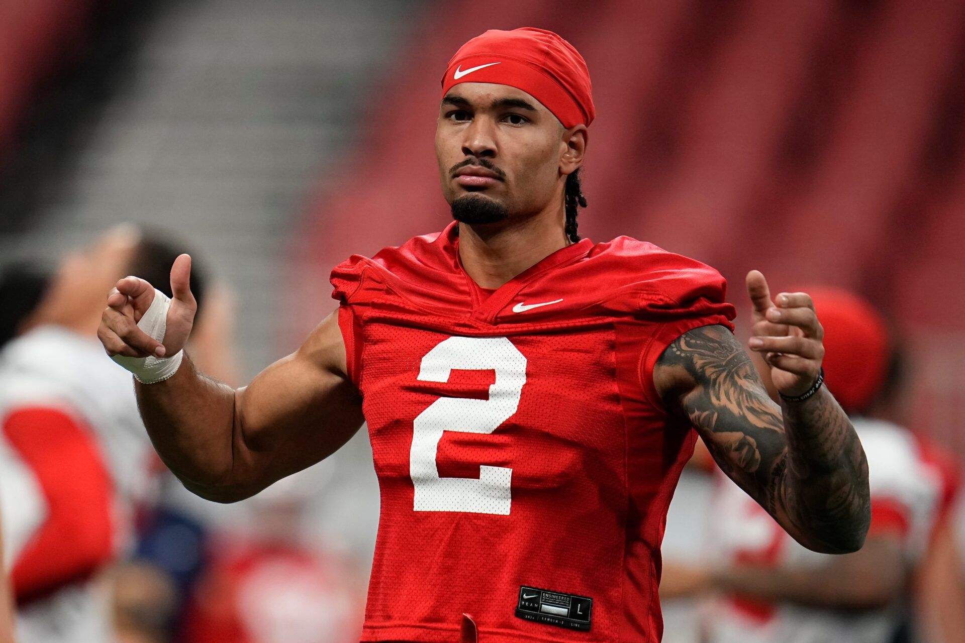 Ohio State Buckeyes wide receiver Emeka Egbuka (2) stretches during practice for the College Football Playoff against the Notre Dame Fighting Irish at the Mercedes-Benz Stadium in Atlanta on Jan. 18, 2025.