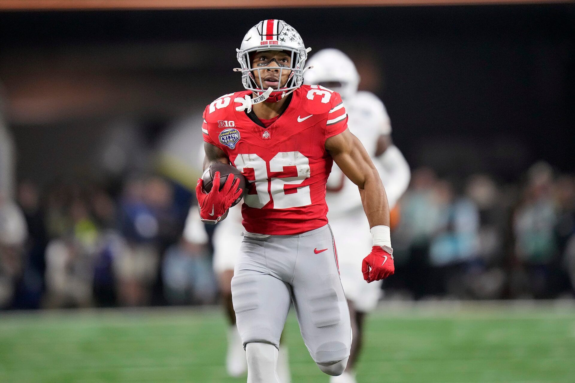 Ohio State Buckeyes running back TreVeyon Henderson (32) scores a touchdown on a 75-yard touchdown catch and run against Texas Longhorns in the second quarter of the Cotton Bowl Classic during the College Football Playoff semifinal game at AT&T Stadium in Arlington, Texas on January, 10, 2025.