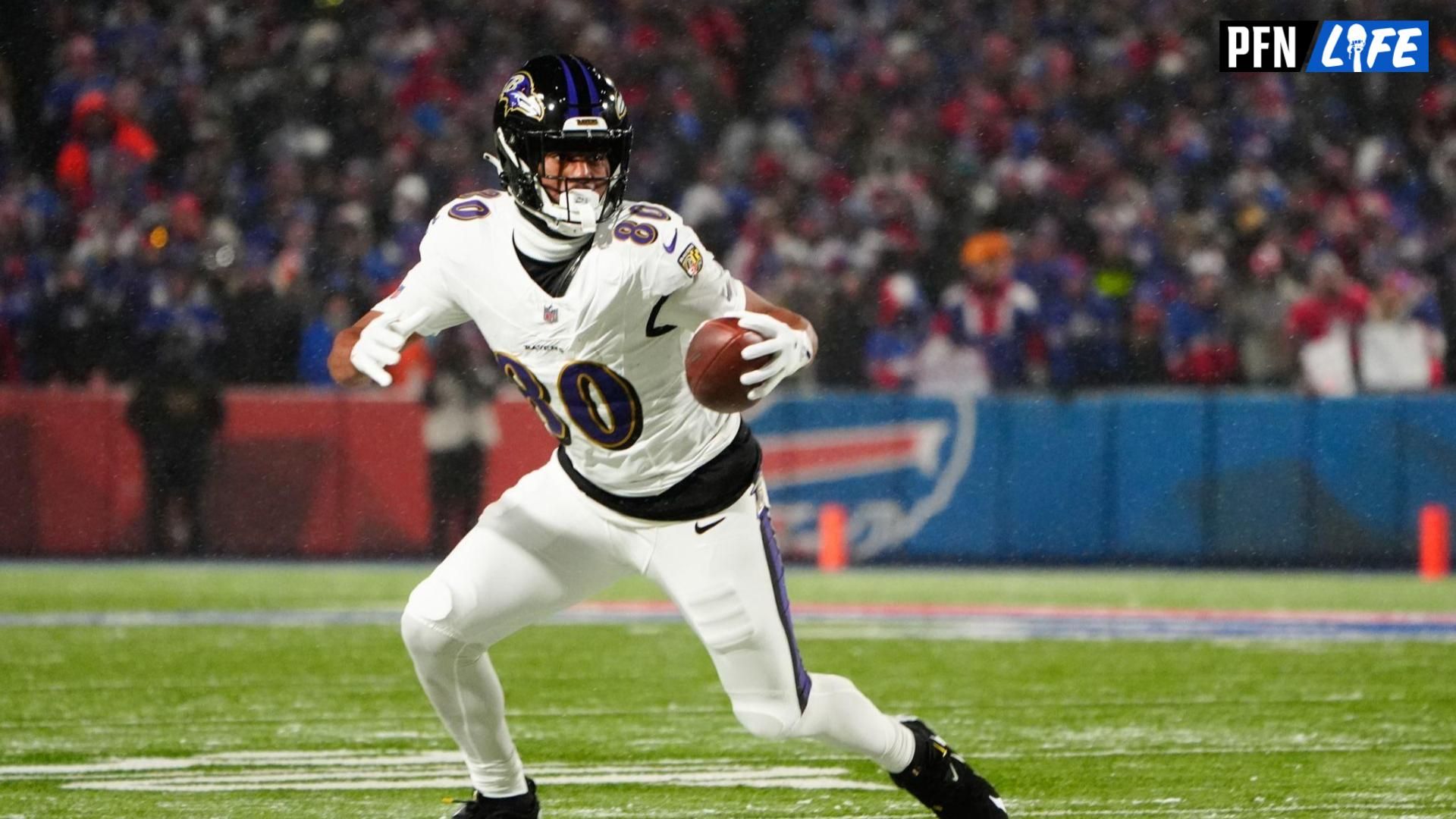 Baltimore Ravens tight end Isaiah Likely (80) runs the ball after making a catch during the first quarter against the Buffalo Bills in a 2025 AFC divisional round game at Highmark Stadium