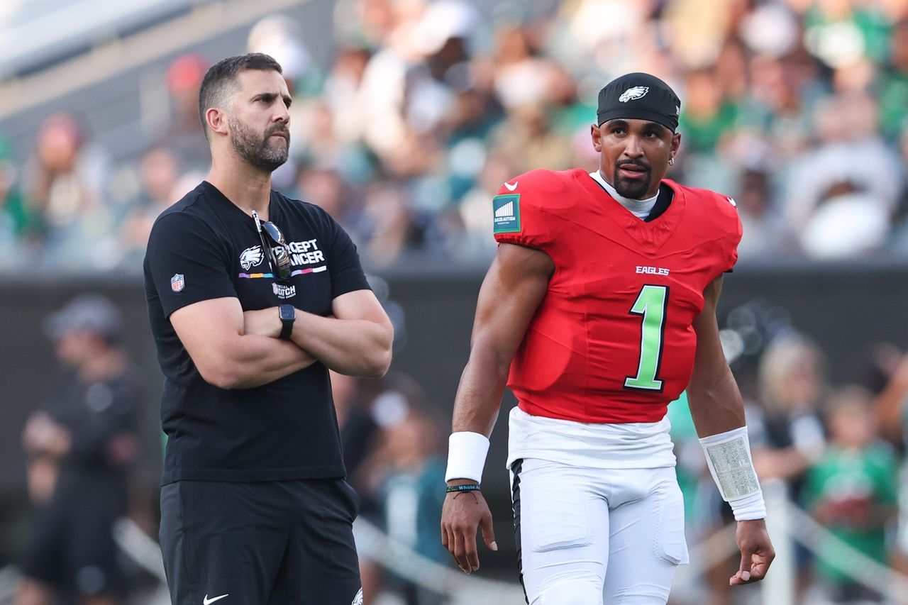 Philadelphia Eagles quarterback Jalen Hurts (1) talks with head coach Nick Sirianni (L) during a practice at Lincoln Financial Field.