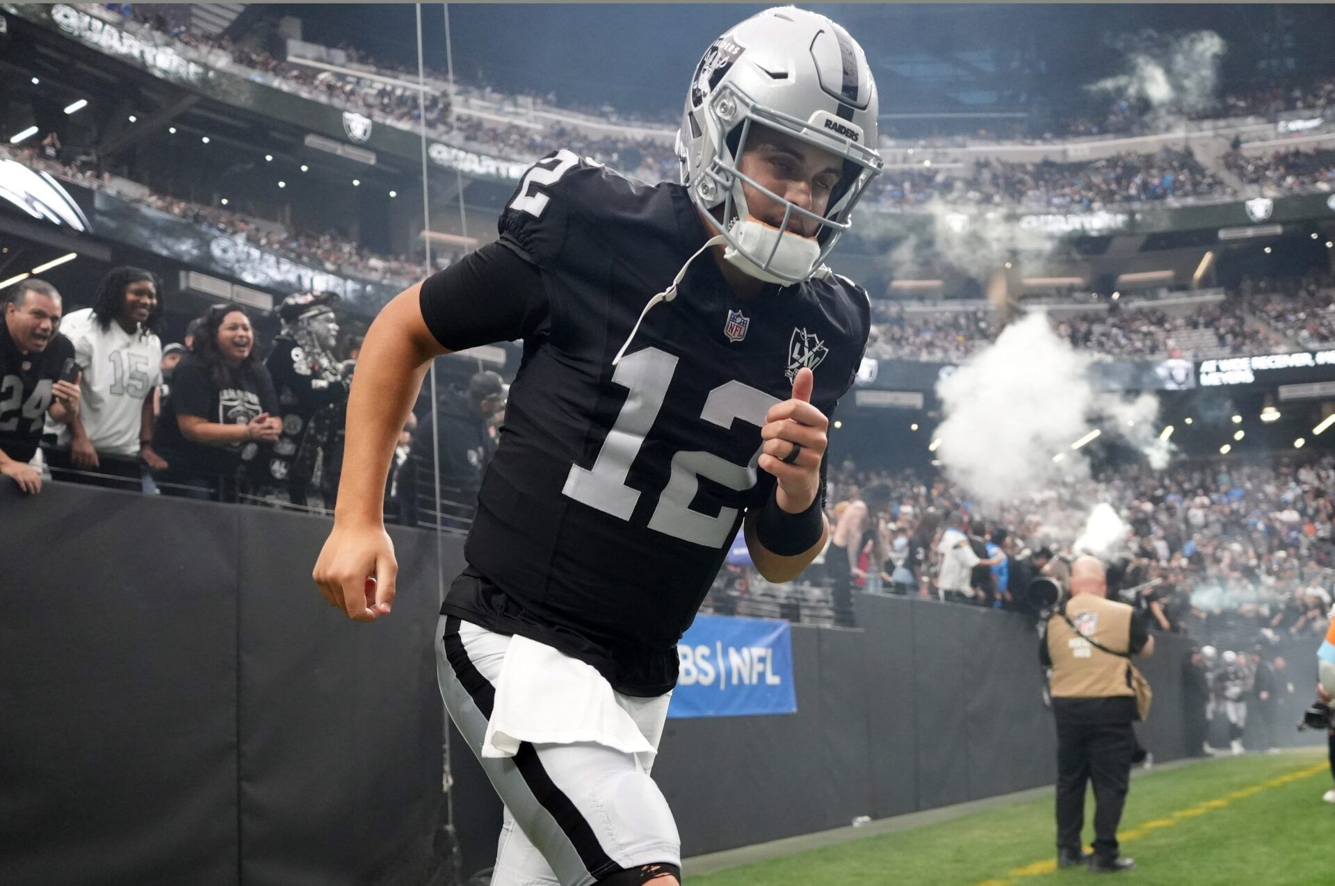 Las Vegas Raiders quarterback Aidan O'Connell (12) enters the field before the game against the Los Angeles Chargers at Allegiant Stadium. Mandatory