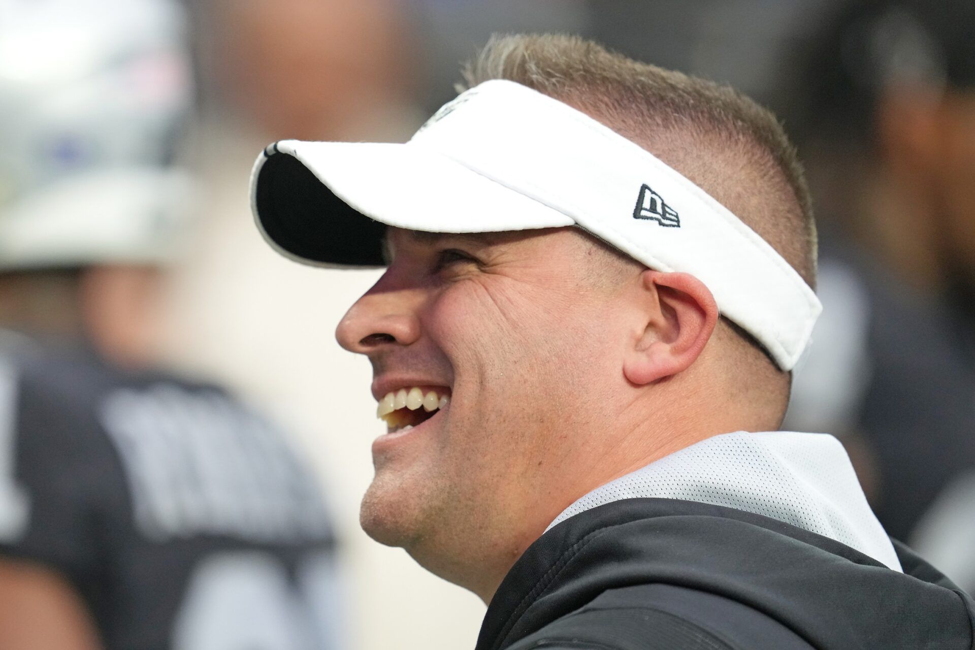 Las Vegas Raiders head coach Josh McDaniels reacts to fans before the start of a game against the New England Patriots at Allegiant Stadium.