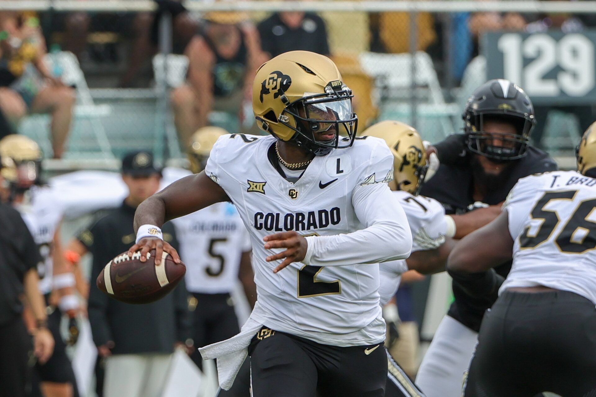 Colorado Buffaloes quarterback Shedeur Sanders (2) rolls out to pass against the UCF Knights during the first quarter at FBC Mortgage Stadium.