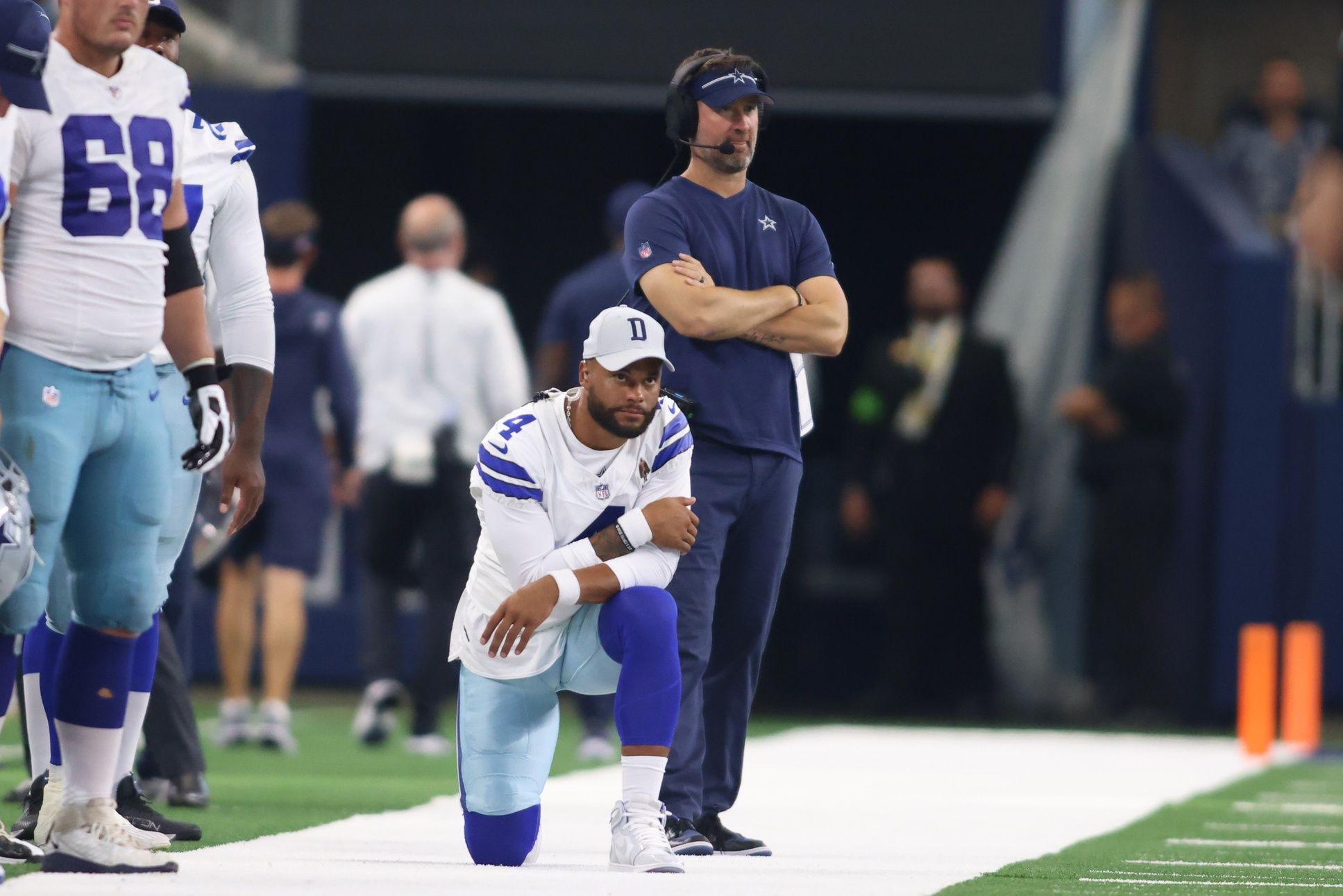 Dallas Cowboys quarterback Dak Prescott (4) and offensive coordinator Brian Schottenheimer watch a play in the game against the Jacksonville Jaguars at AT&T Stadium.