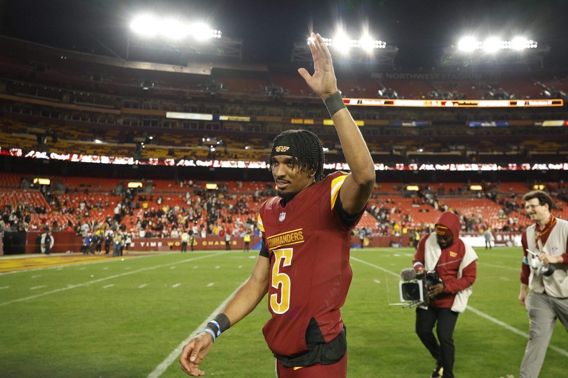 Washington Commanders quarterback Jayden Daniels (5) celebrates while leaving the field after the Commanders' game against the Atlanta Falcons at Northwest Stadium.