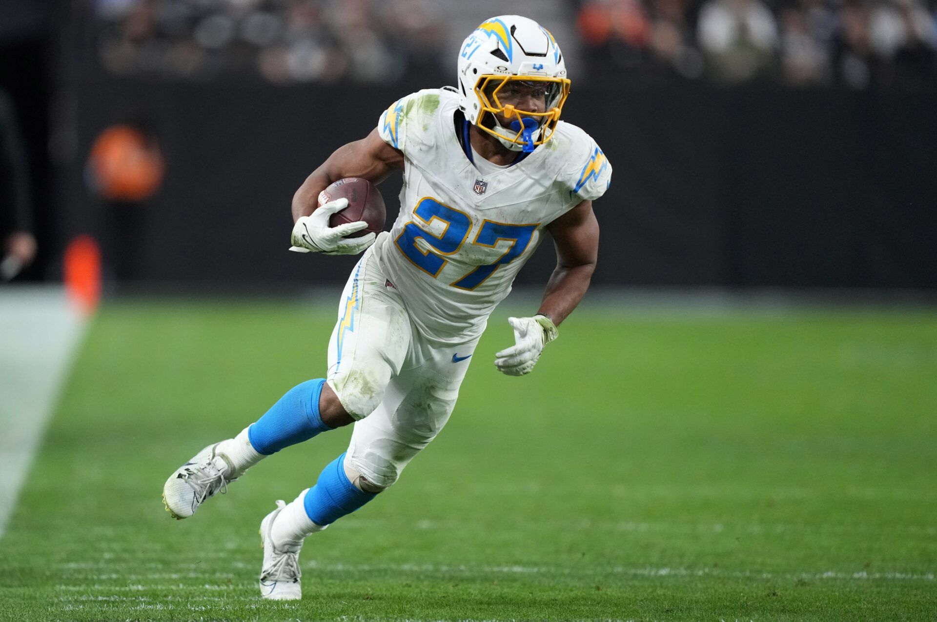 Los Angeles Chargers running back J.K. Dobbins (27) carries the ball against the Las Vegas Raiders in the second half at Allegiant Stadium.